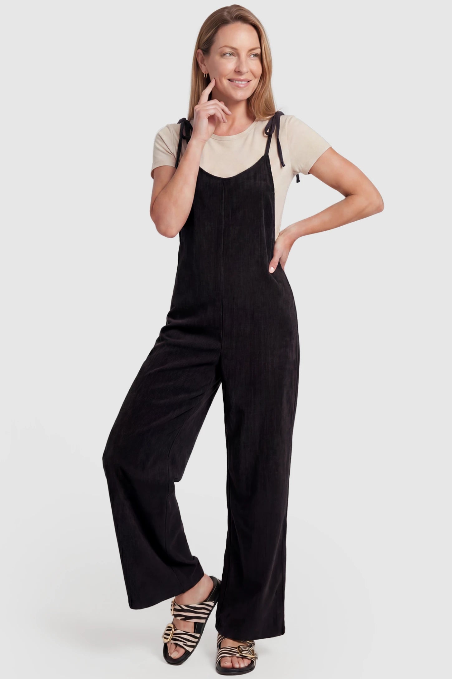 Solid Sleeveless Wide Leg Maternity Jumpsuit Solid Sleeveless Wide Leg Maternity Jumpsuit in Black featuring a flowy silhouette on a postpartum model, front view.