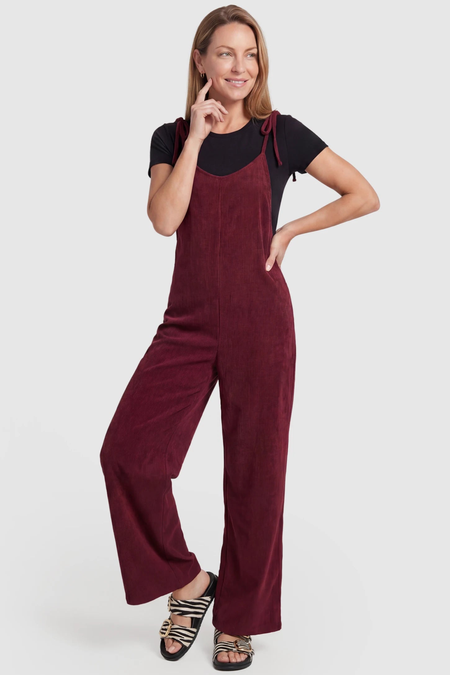 Solid Sleeveless Wide Leg Maternity Jumpsuit Solid Sleeveless Wide Leg Maternity Jumpsuit in Wine Red featuring a flowy silhouette on a postpartum model, front view.