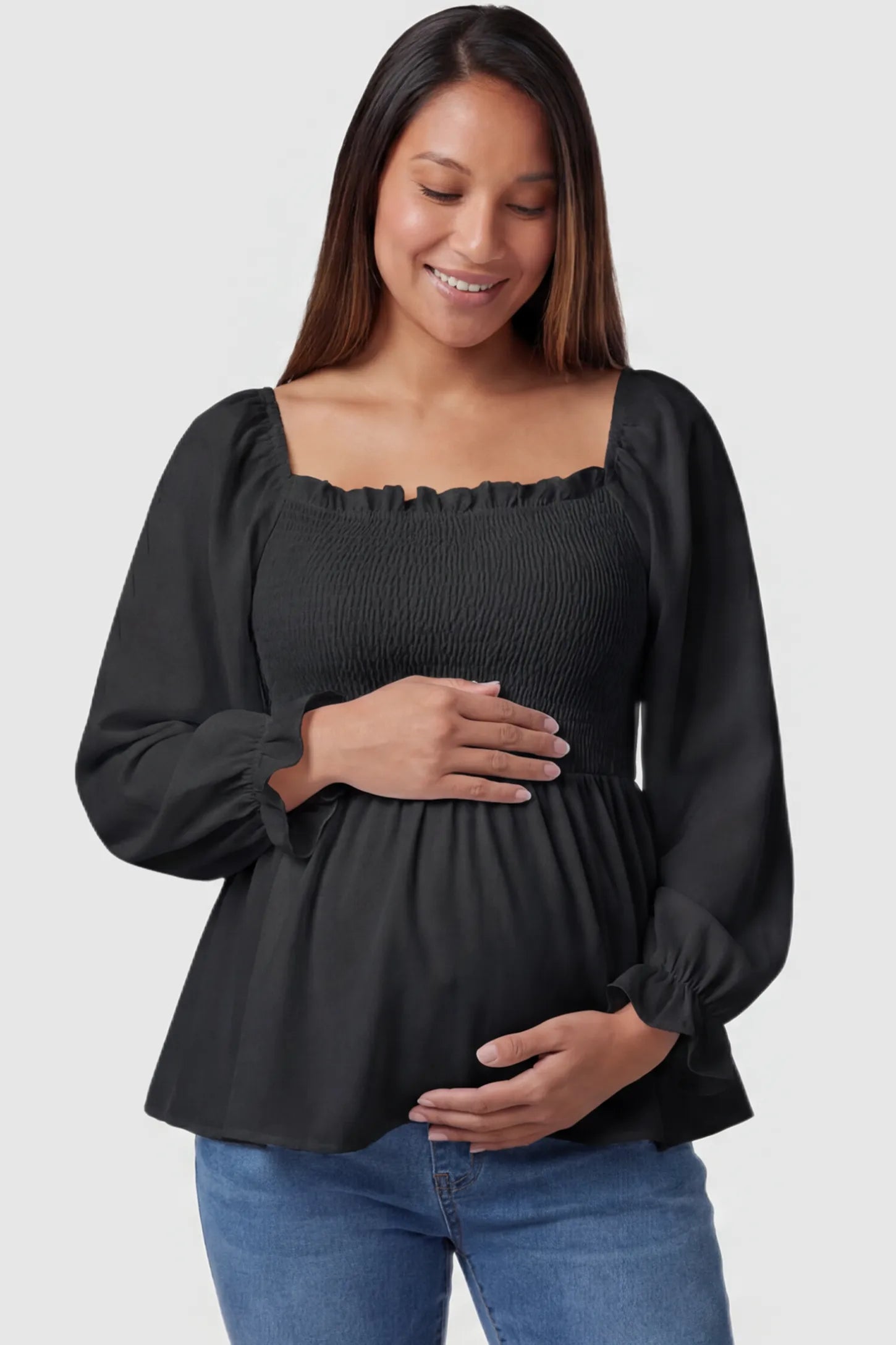 Smocked Convertible Neckline Bishop Sleeve Maternity Top Smocked Convertible Neckline Bishop Sleeve Maternity Top in Black featuring a smocked bodice on a pregnant model front view.