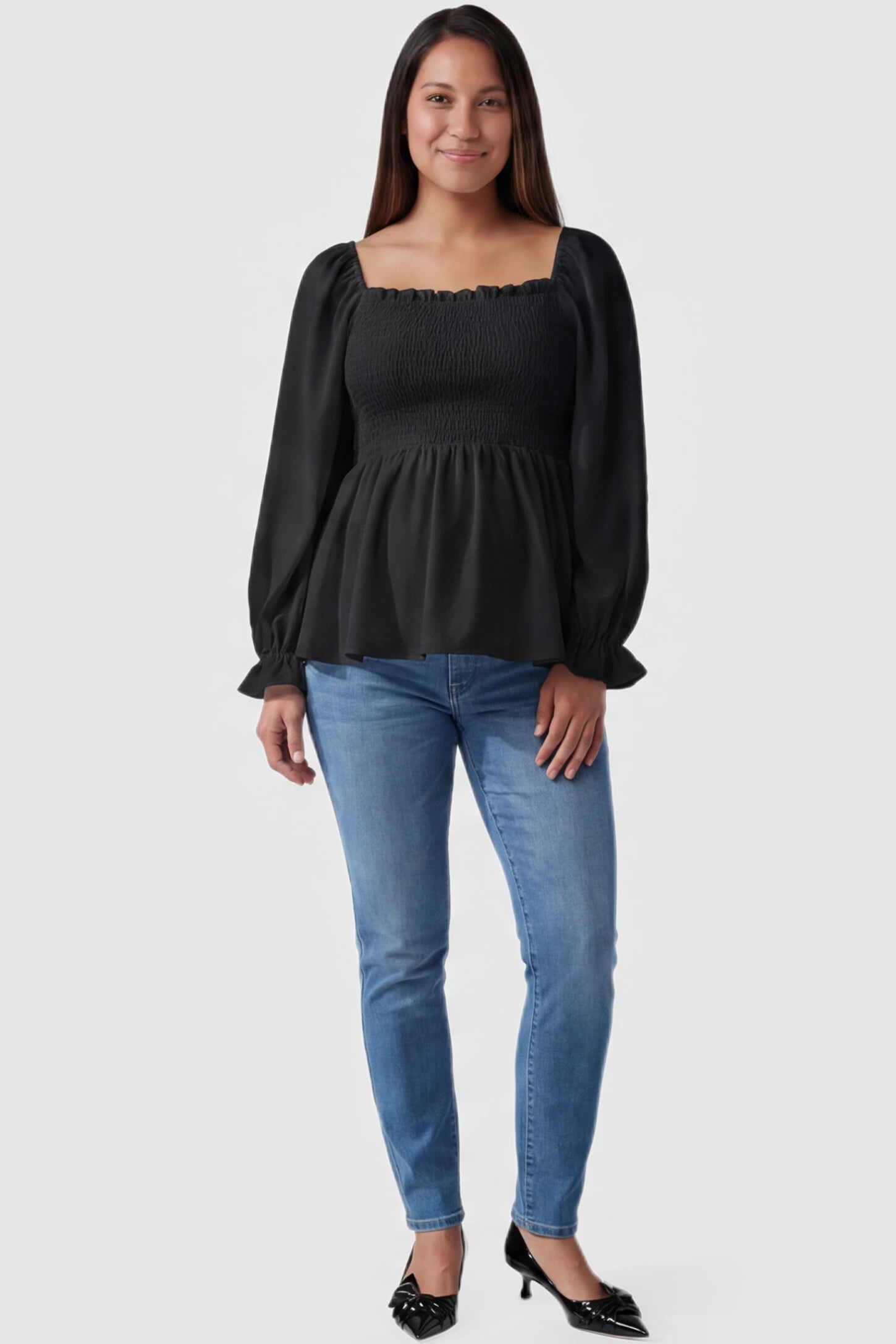 Smocked Convertible Neckline Bishop Sleeve Maternity Top Smocked Convertible Neckline Bishop Sleeve Maternity Top in Black featuring a smocked bodice on a pregnant model full body view.