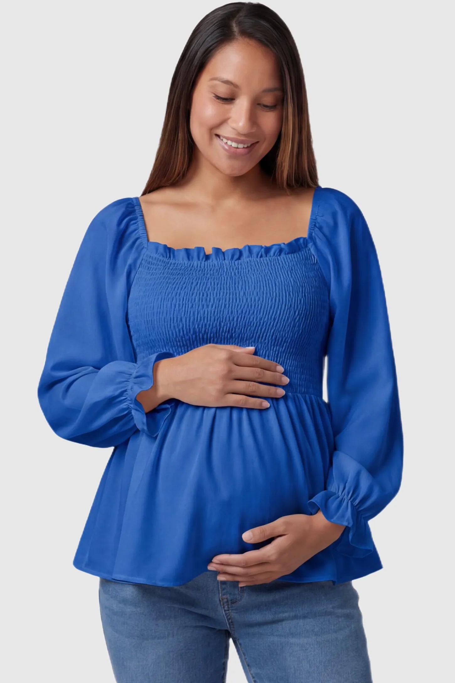 Smocked Convertible Neckline Bishop Sleeve Maternity Top Smocked Convertible Neckline Bishop Sleeve Maternity Top in Blue featuring a smocked bodice on a pregnant model front view.
