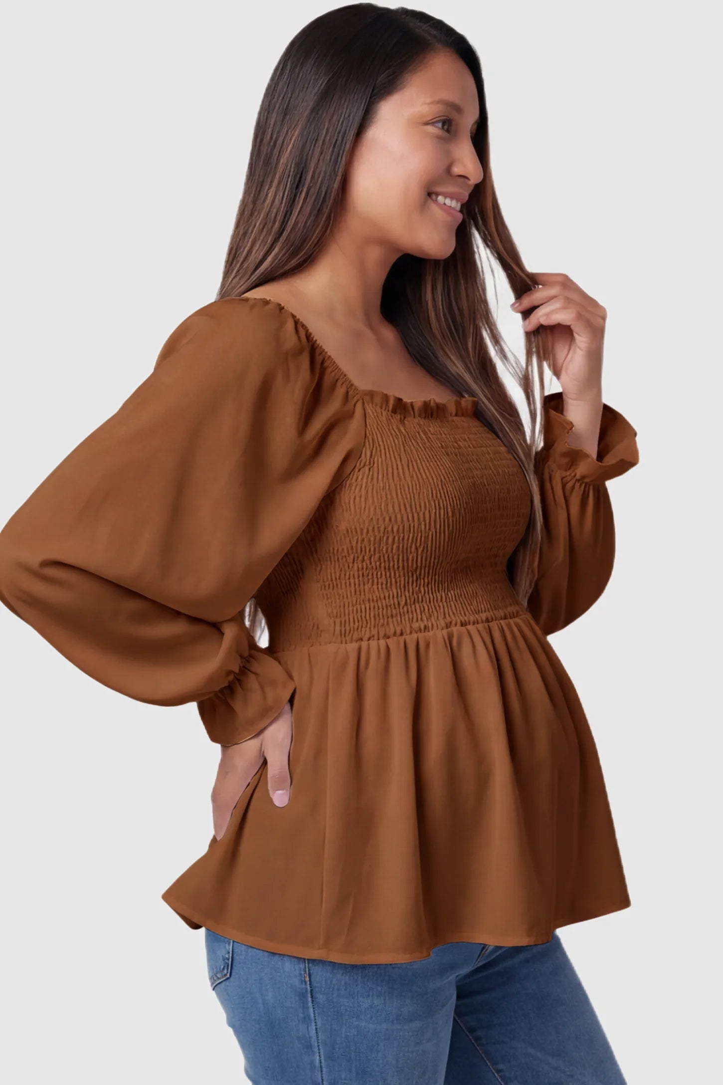Smocked Convertible Neckline Bishop Sleeve Maternity Top Smocked Convertible Neckline Bishop Sleeve Maternity Top in Coffee featuring a peplum hem on a pregnant model side view.