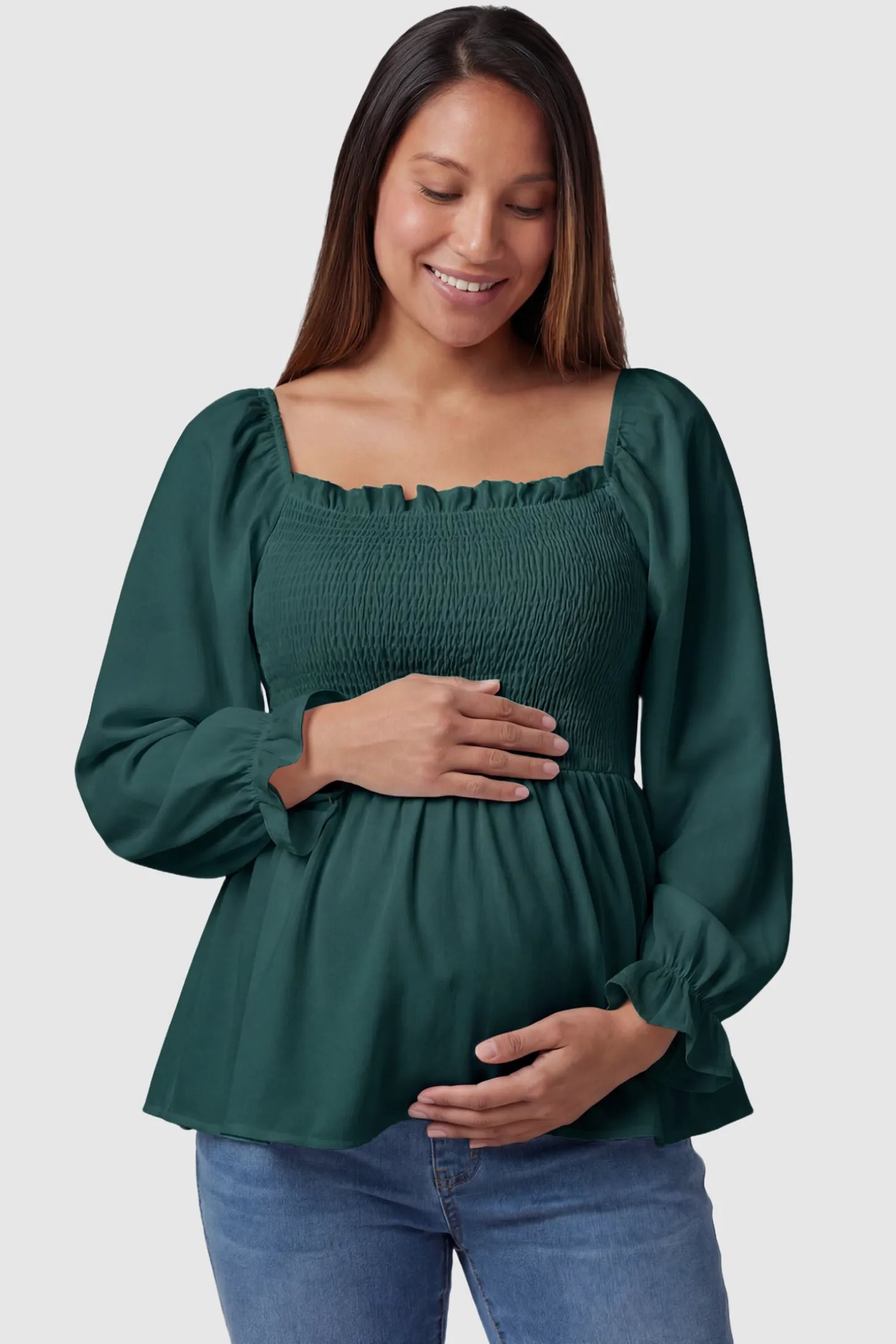 Smocked Convertible Neckline Bishop Sleeve Maternity Top in Green featuring a smocked bodice on a pregnant model front view.