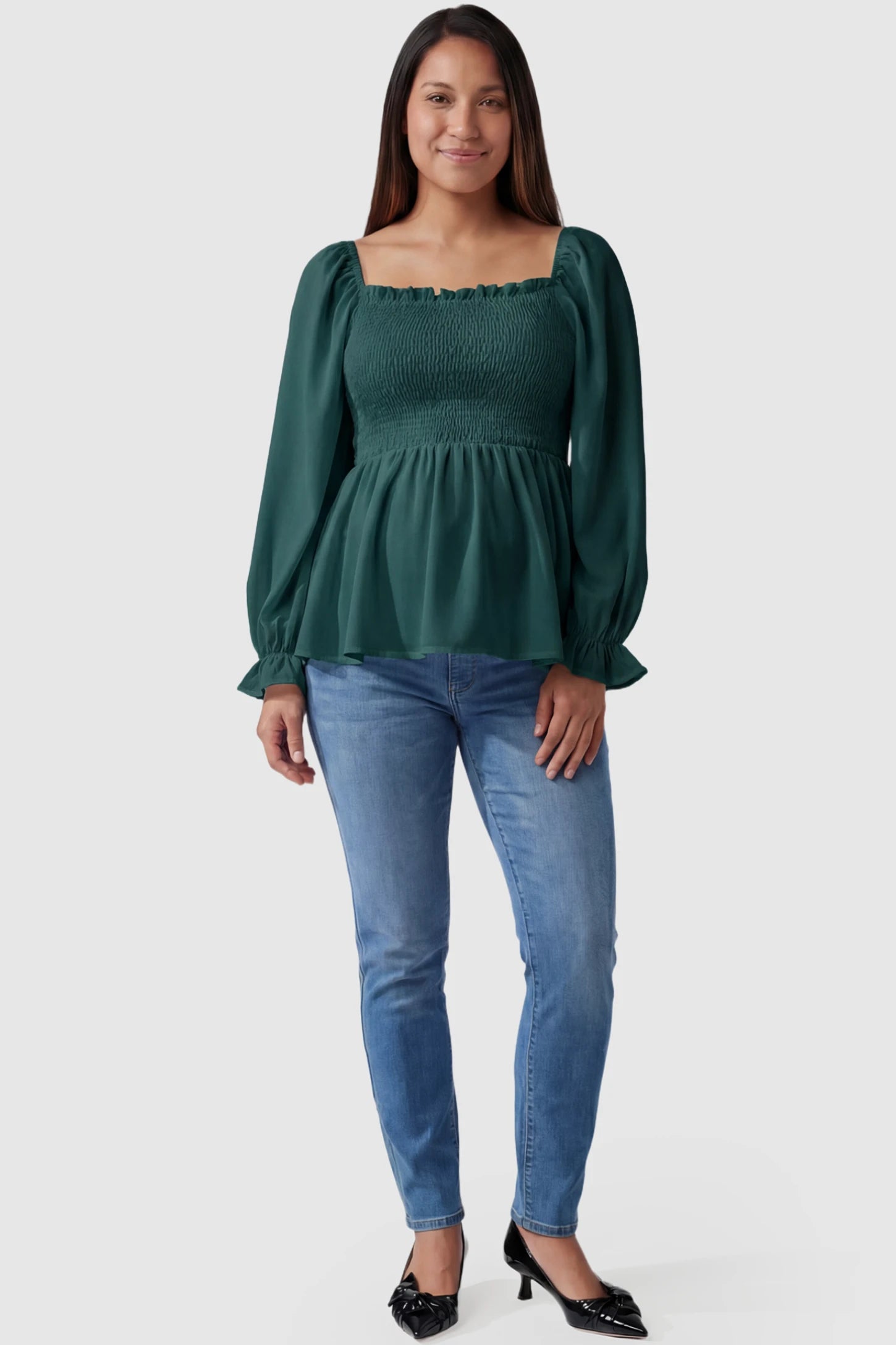 Smocked Convertible Neckline Bishop Sleeve Maternity Top Smocked Convertible Neckline Bishop Sleeve Maternity Top in Green featuring a smocked bodice on a pregnant model full body view.
