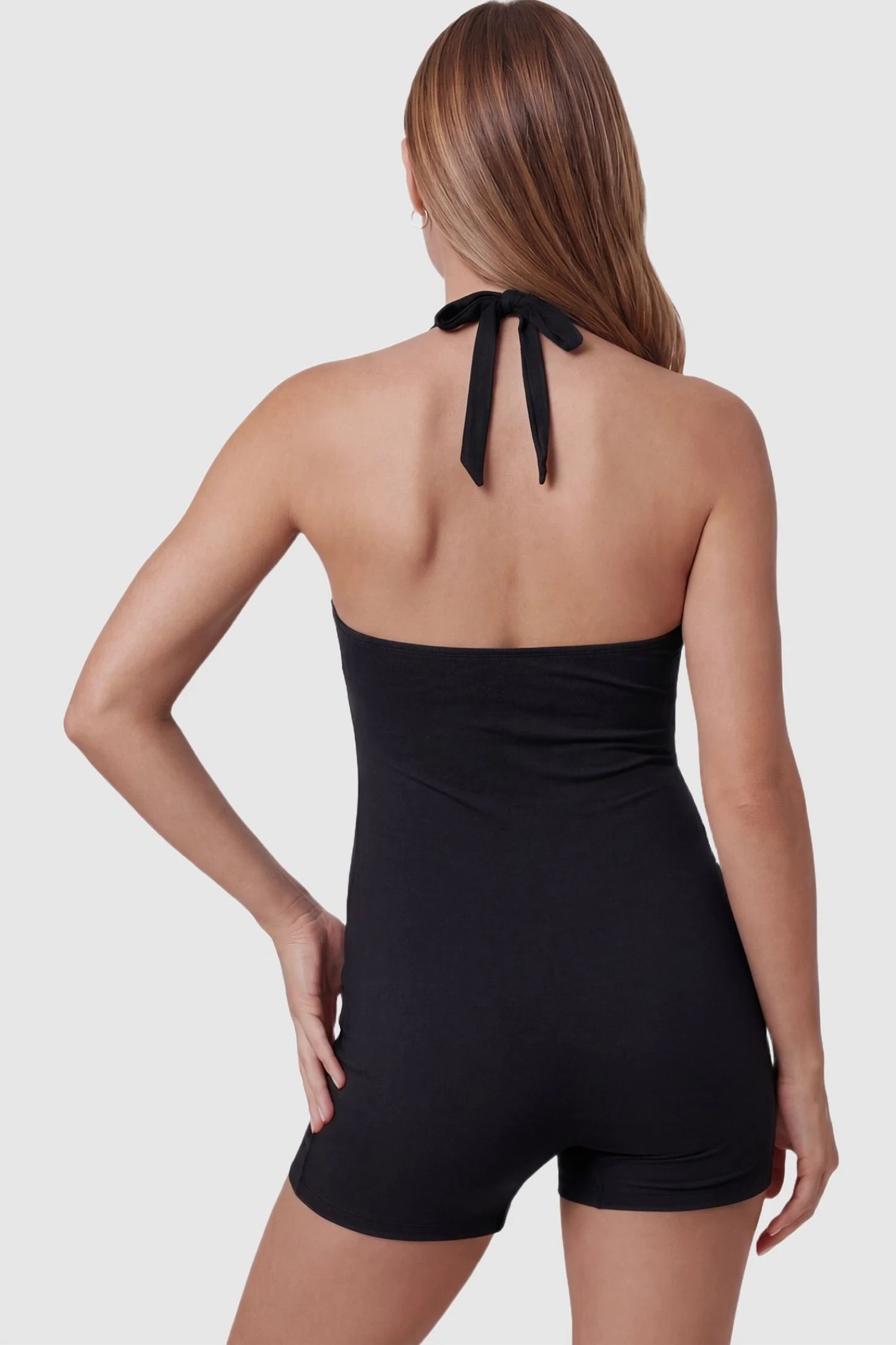 Smooth Halter Stretch Fit Maternity Swim Romper Smooth Halter Stretch Fit Maternity Swim Romper in Black featuring an adjustable tie-back halter neck on a back-view pregnant model.