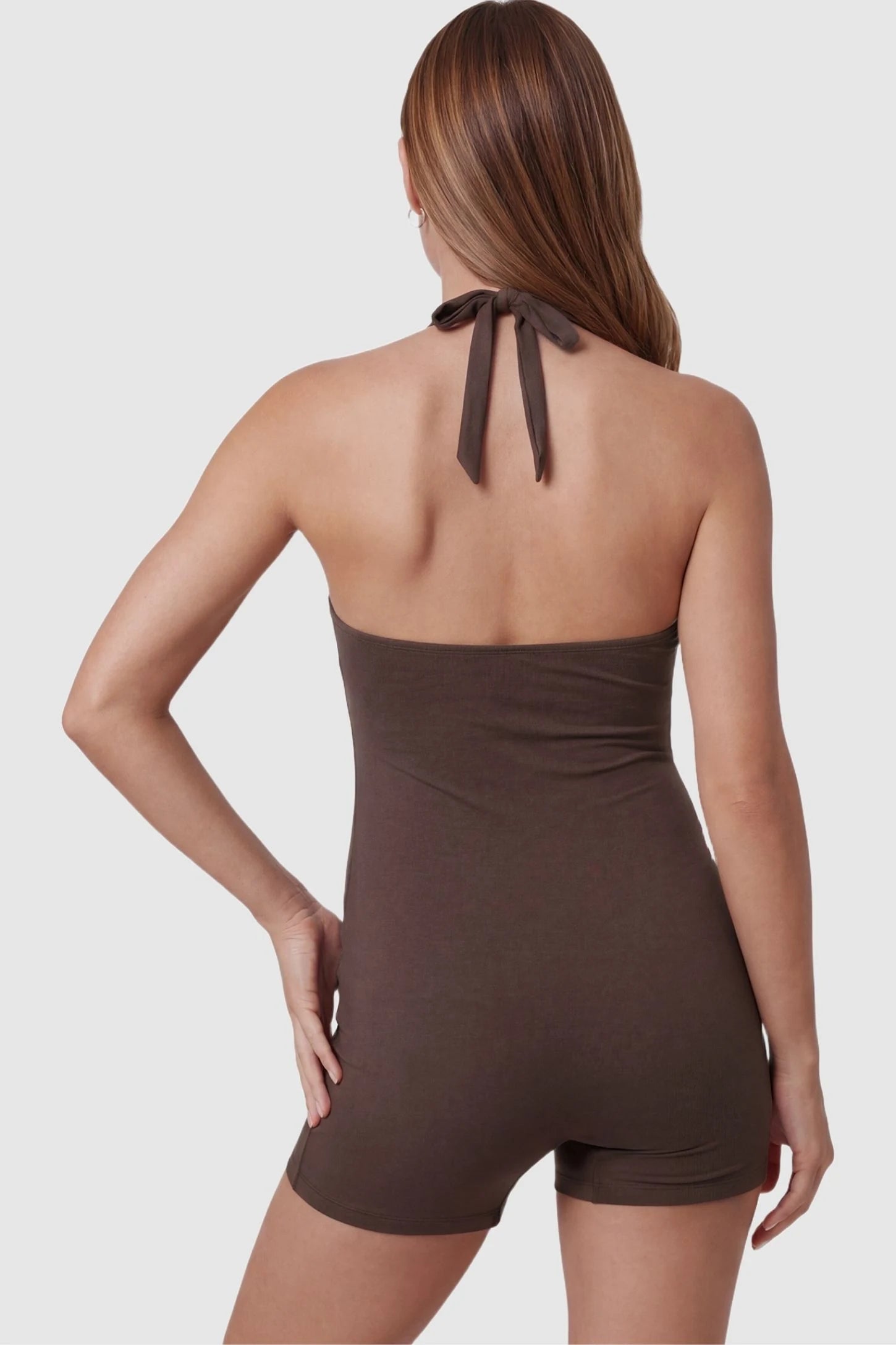Smooth Halter Stretch Fit Maternity Swim Romper Smooth Halter Stretch Fit Maternity Swim Romper in Brown featuring an adjustable tie-back halter neck on a back-view pregnant model.