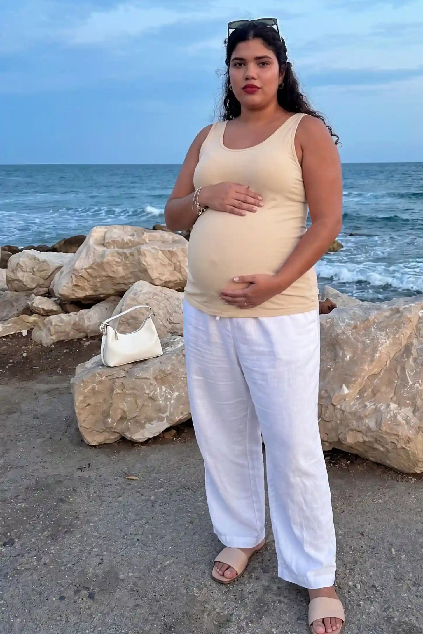 Soft Knit Sleeveless Maternity Tank Top Soft Knit Sleeveless Maternity Tank Top in Beige featuring a longline silhouette on a pregnant model