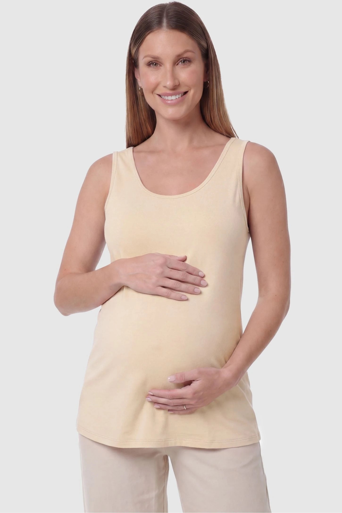 Soft Knit Sleeveless Maternity Tank Top Soft Knit Sleeveless Maternity Tank Top in Beige featuring a scoop neckline on a pregnant model, front view.
