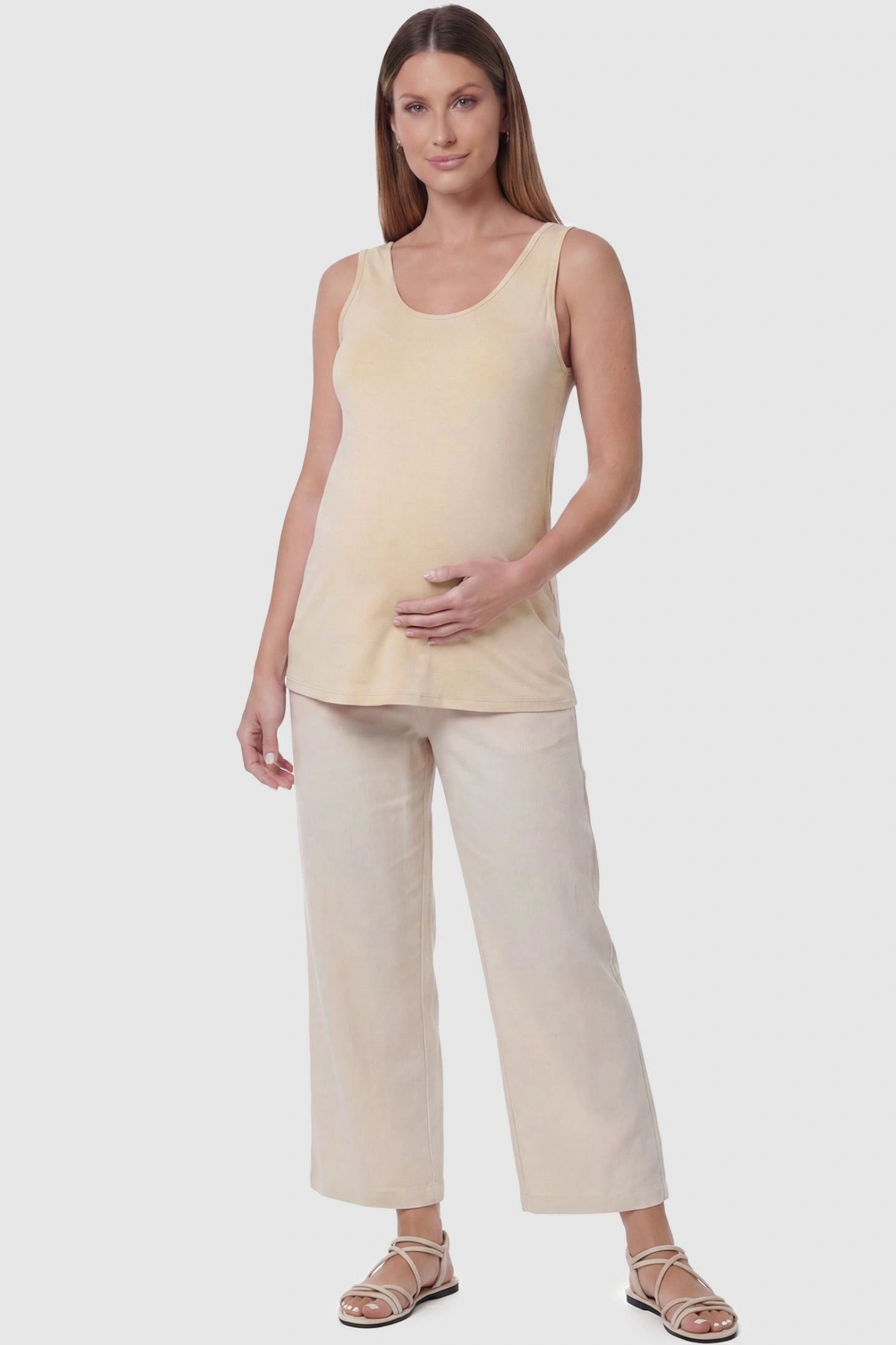Soft Knit Sleeveless Maternity Tank Top Soft Knit Sleeveless Maternity Tank Top in Beige featuring a scoop neckline on a pregnant model, front view.