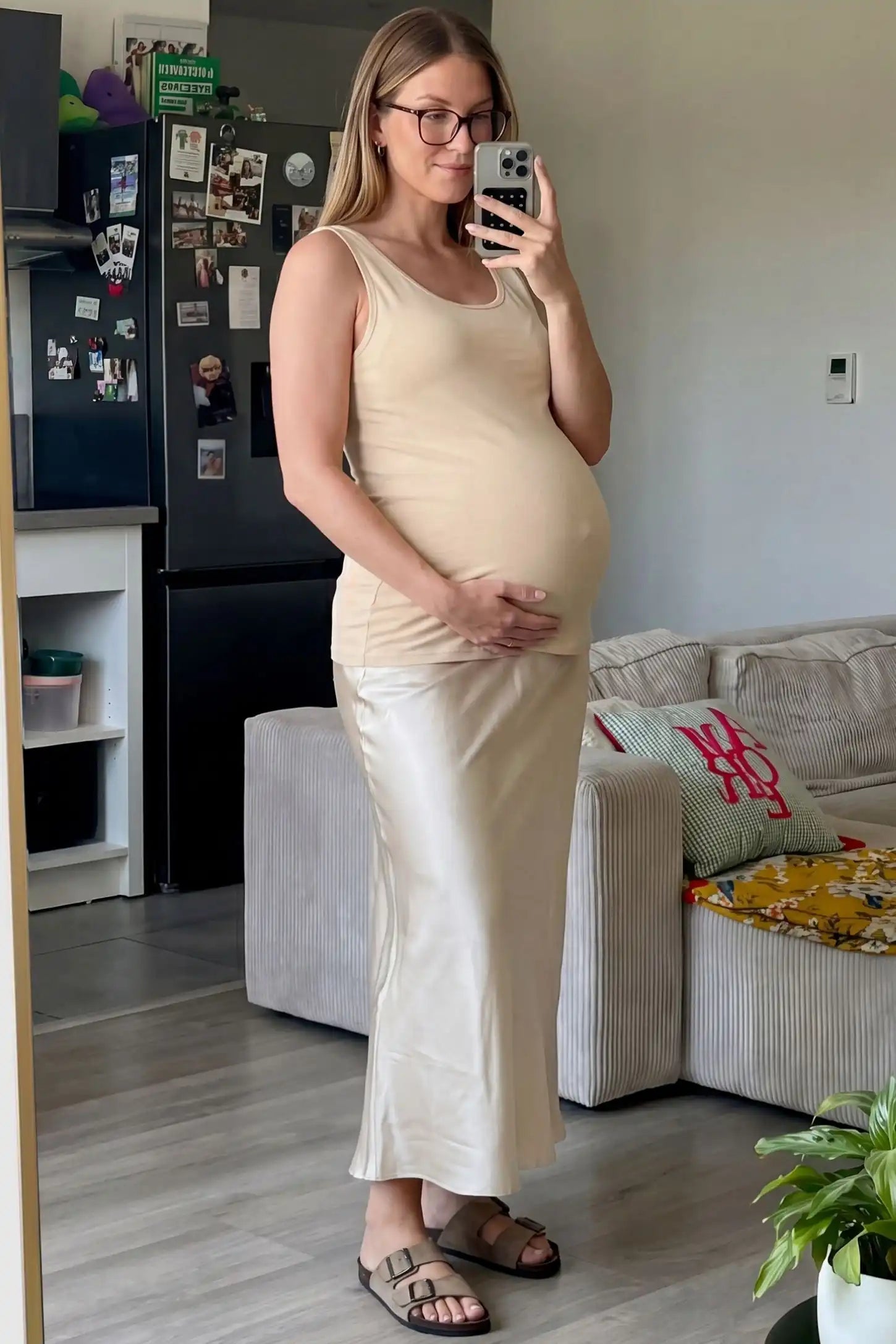 Soft Knit Sleeveless Maternity Tank Top Soft Knit Sleeveless Maternity Tank Top in Beige featuring stretchy breathable fabric on a pregnant woman in a mirror selfie.