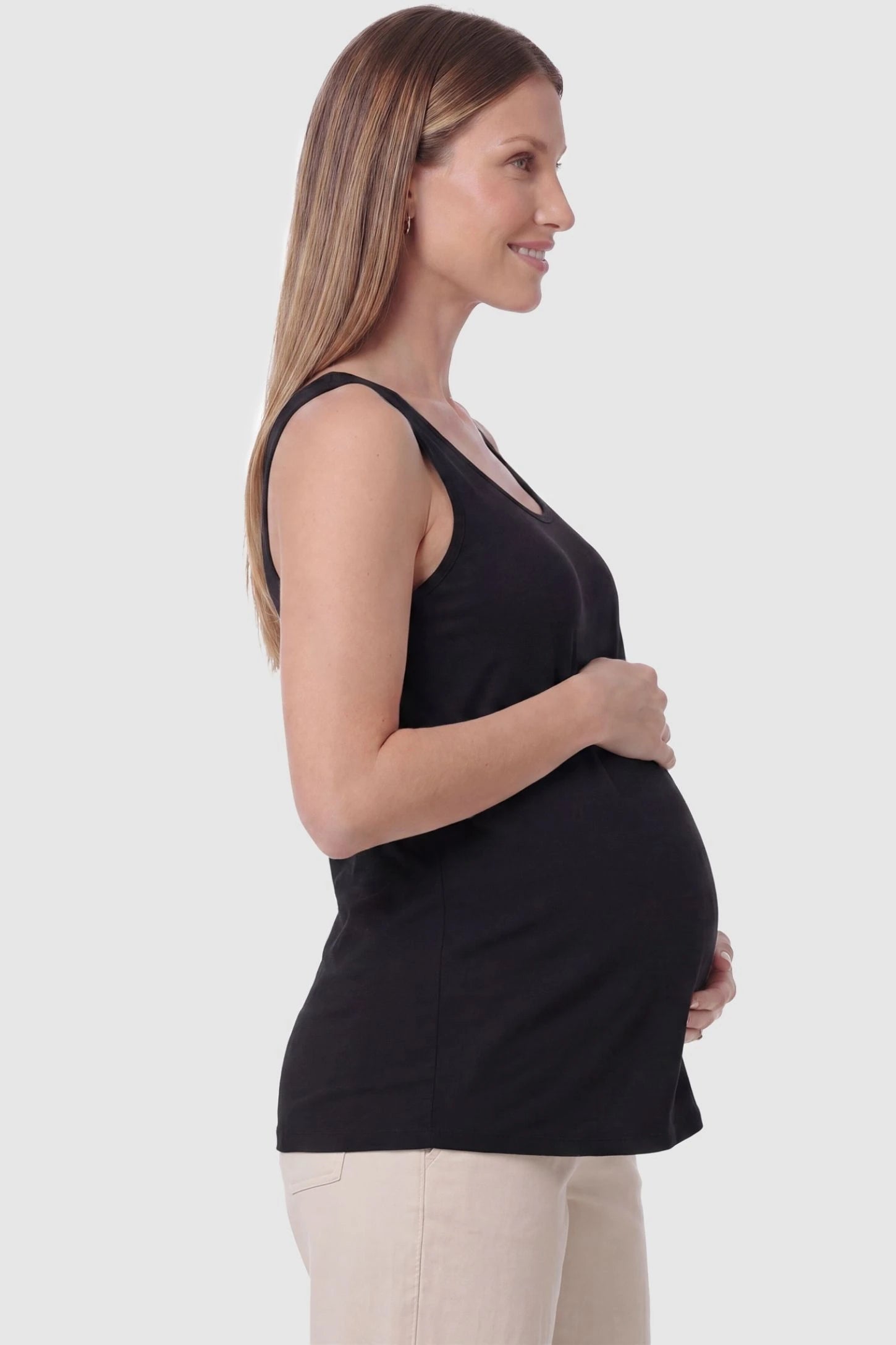 Soft Knit Sleeveless Maternity Tank Top Soft Knit Sleeveless Maternity Tank Top in Black featuring a straight hemline on a pregnant model, side view.