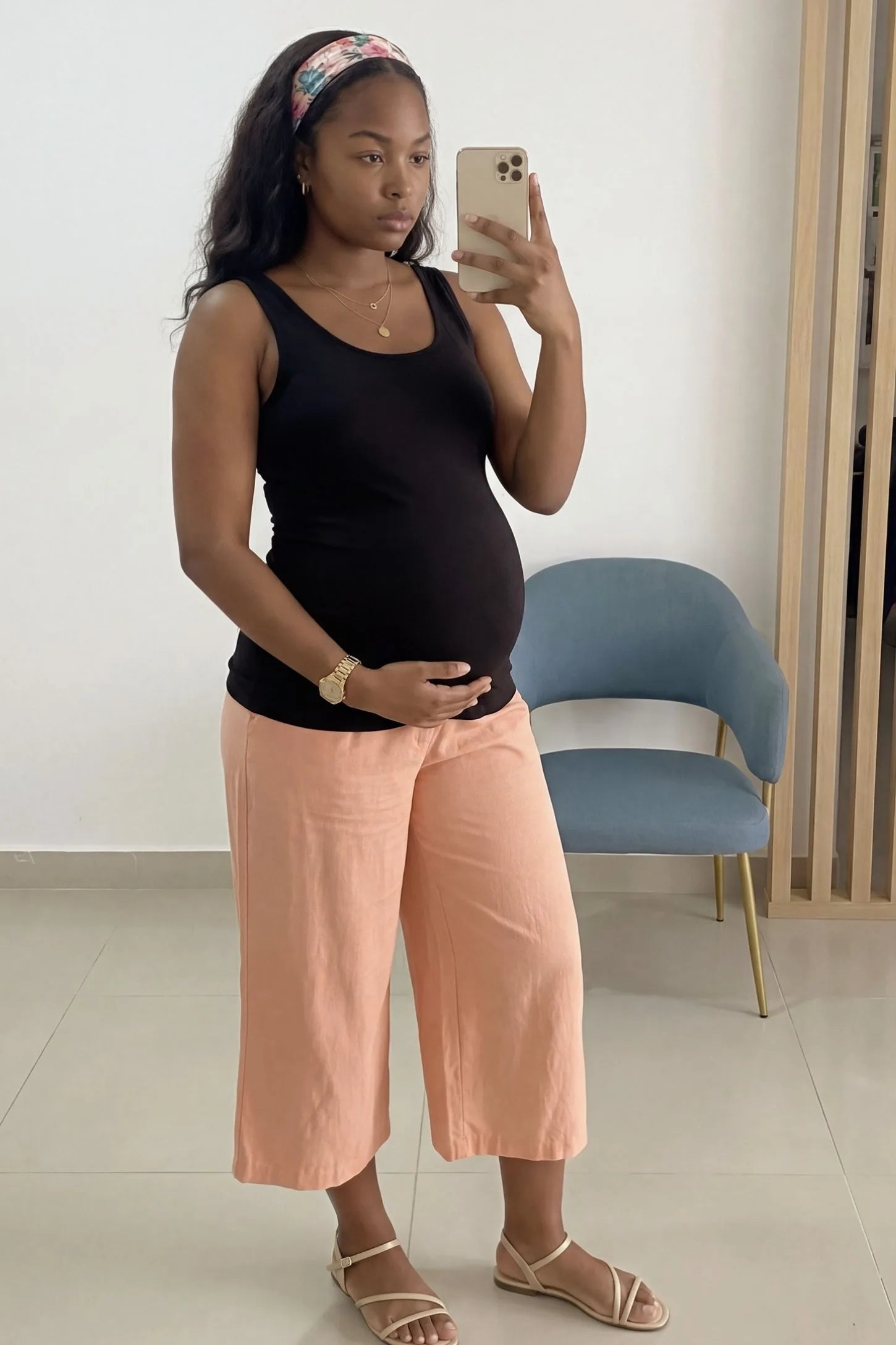 Soft Knit Sleeveless Maternity Tank Top Soft Knit Sleeveless Maternity Tank Top in Black featuring stretchy breathable fabric on a pregnant woman in a mirror selfie.