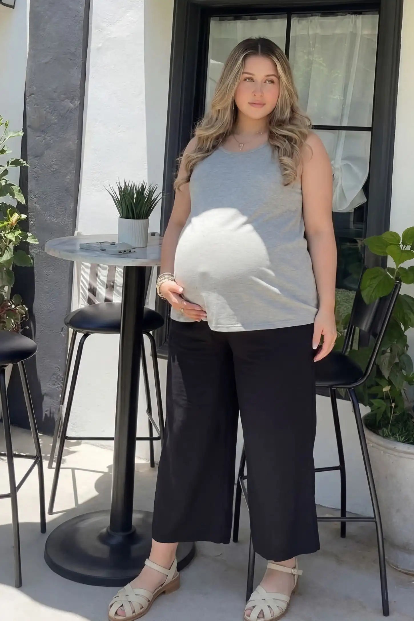 Soft Knit Sleeveless Maternity Tank Top Soft Knit Sleeveless Maternity Tank Top in Gray featuring a longline silhouette on a pregnant model in a garden setting.