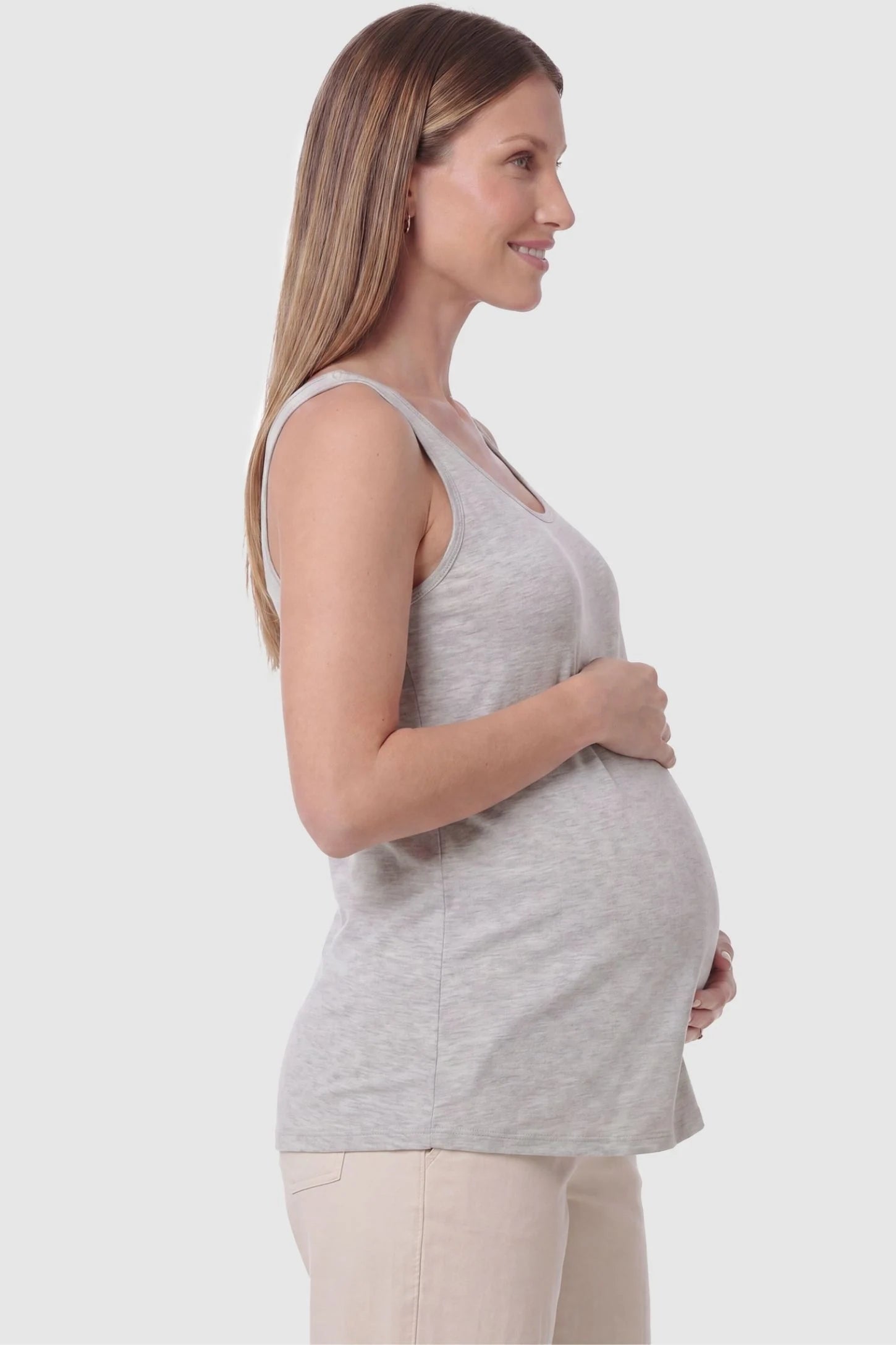Soft Knit Sleeveless Maternity Tank Top Soft Knit Sleeveless Maternity Tank Top in Gray featuring a straight hemline on a pregnant model, side view.