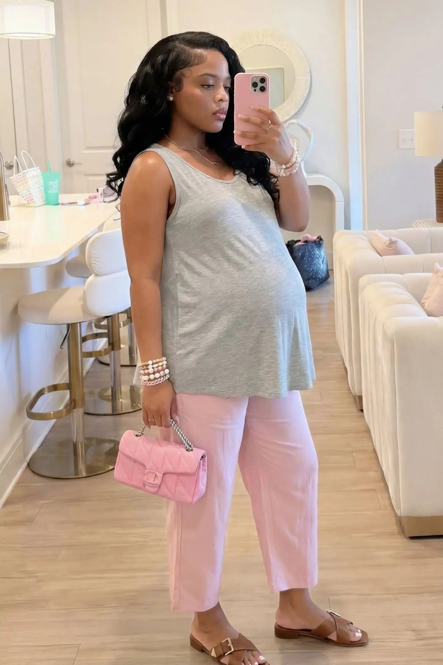 Soft Knit Sleeveless Maternity Tank Top Soft Knit Sleeveless Maternity Tank Top in Gray featuring stretchy breathable fabric on a pregnant woman in a mirror selfie.