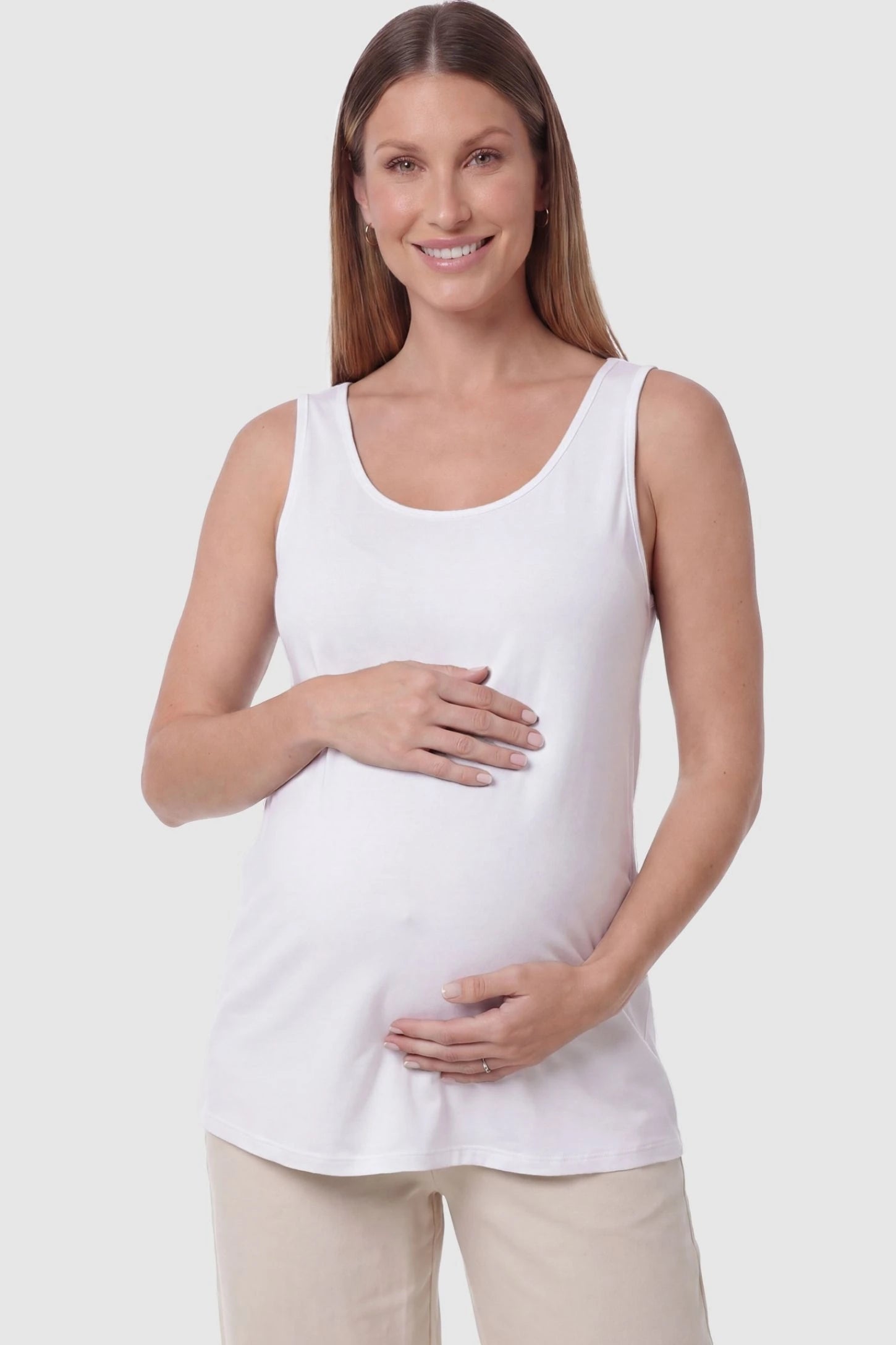 Soft Knit Sleeveless Maternity Tank Top in White featuring a scoop neckline on a pregnant model, front view.