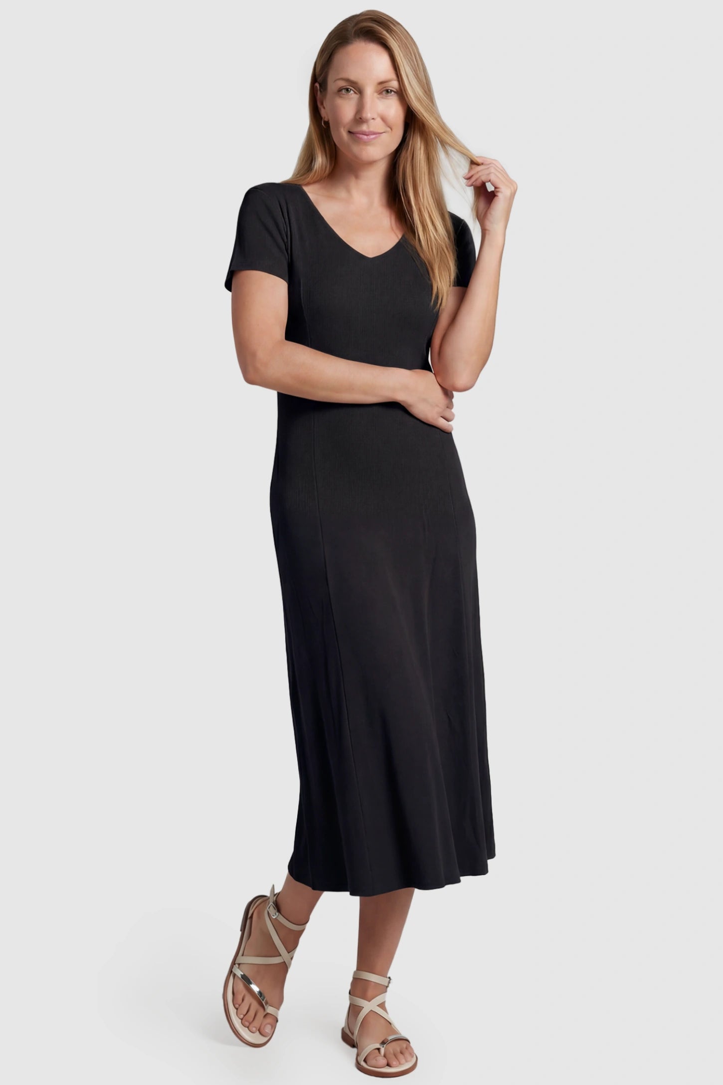 Soft Knit Stretch Short Sleeve Maternity Midi Dress Soft Knit Stretch Short Sleeve Maternity Midi Dress in Black featuring a flattering v-neck and high stretch knit on a postpartum model, front view.