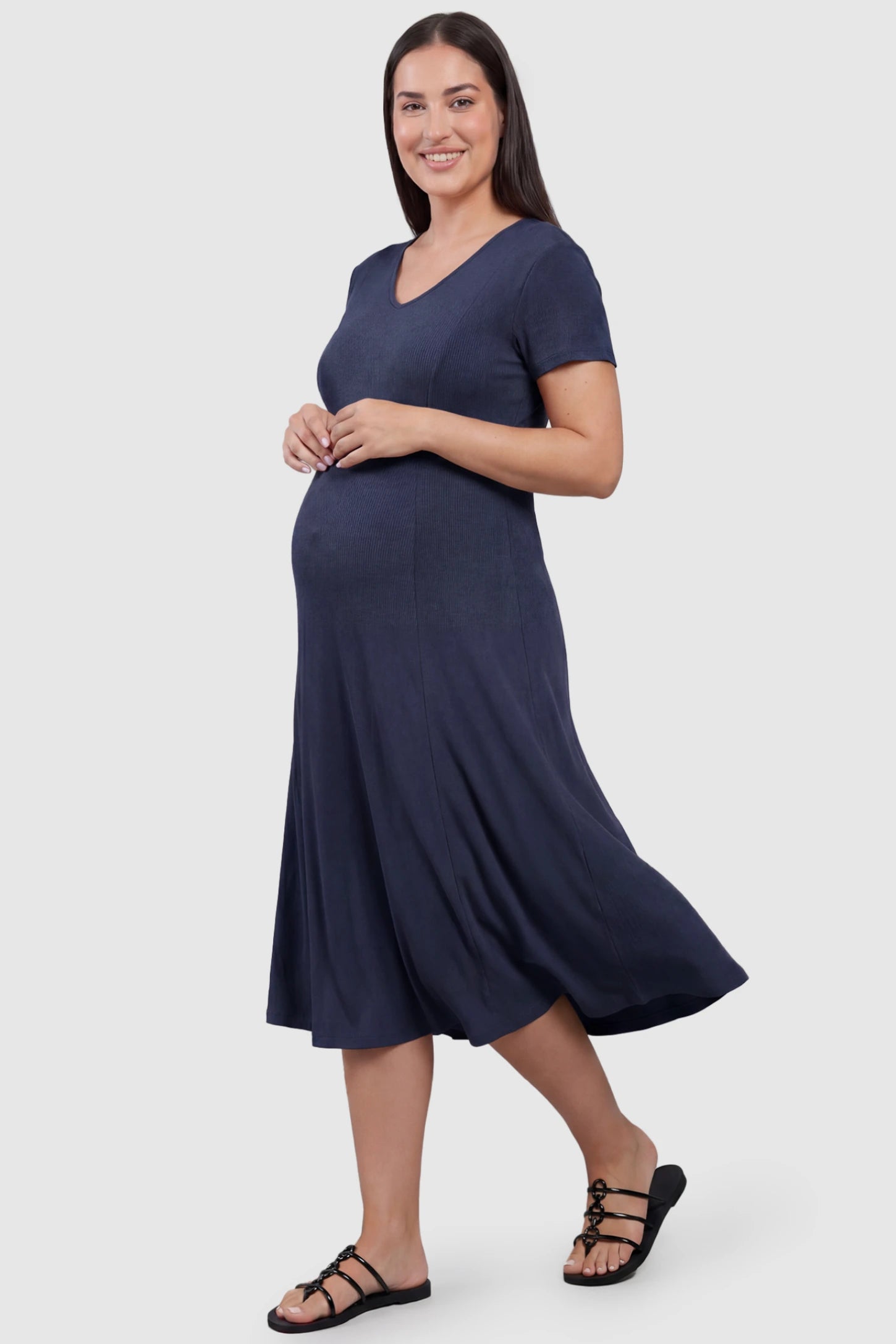 Soft Knit Stretch Short Sleeve Maternity Midi Dress Soft Knit Stretch Short Sleeve Maternity Midi Dress in Dark Gray featuring a flattering v-neck and high stretch knit on a plus size pregnant model, front view.