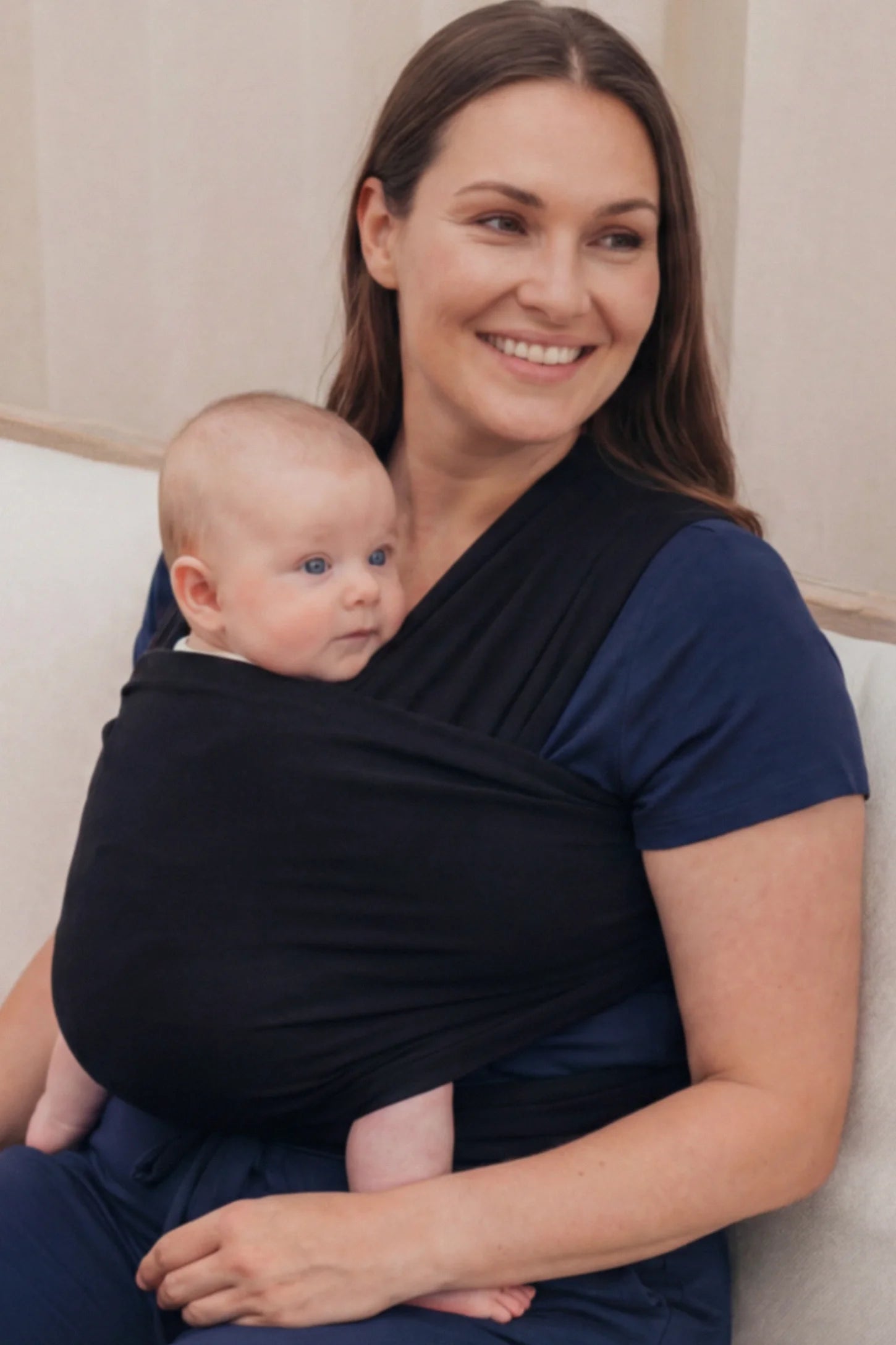 Soft Stretch Adjustable Baby Wrap Carrier Soft Stretch Adjustable Baby Wrap Carrier in Black featuring a polyester blend holding a baby.
