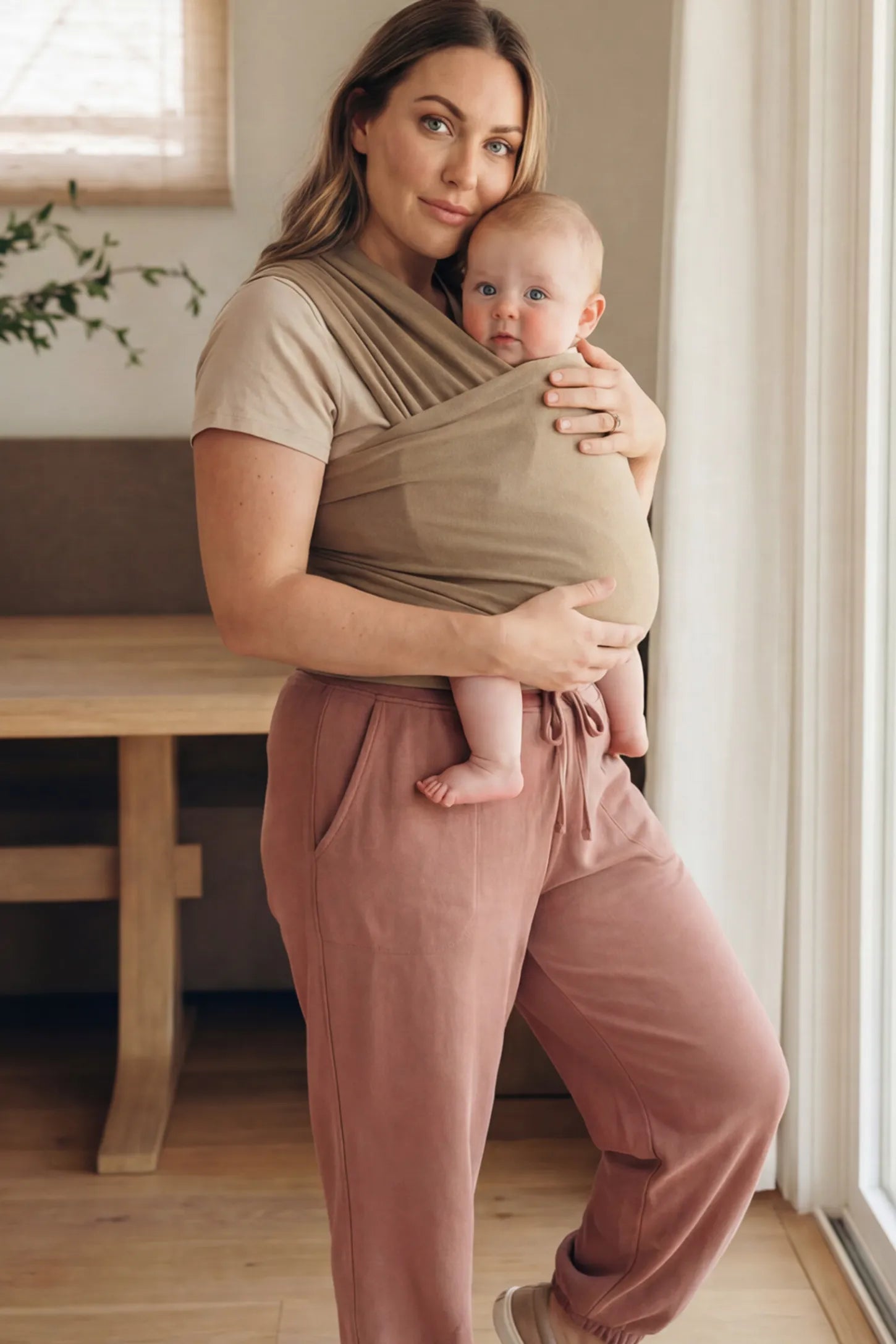 Soft Stretch Adjustable Baby Wrap Carrier Soft Stretch Adjustable Baby Wrap Carrier in Coffee featuring a polyester blend holding a baby.