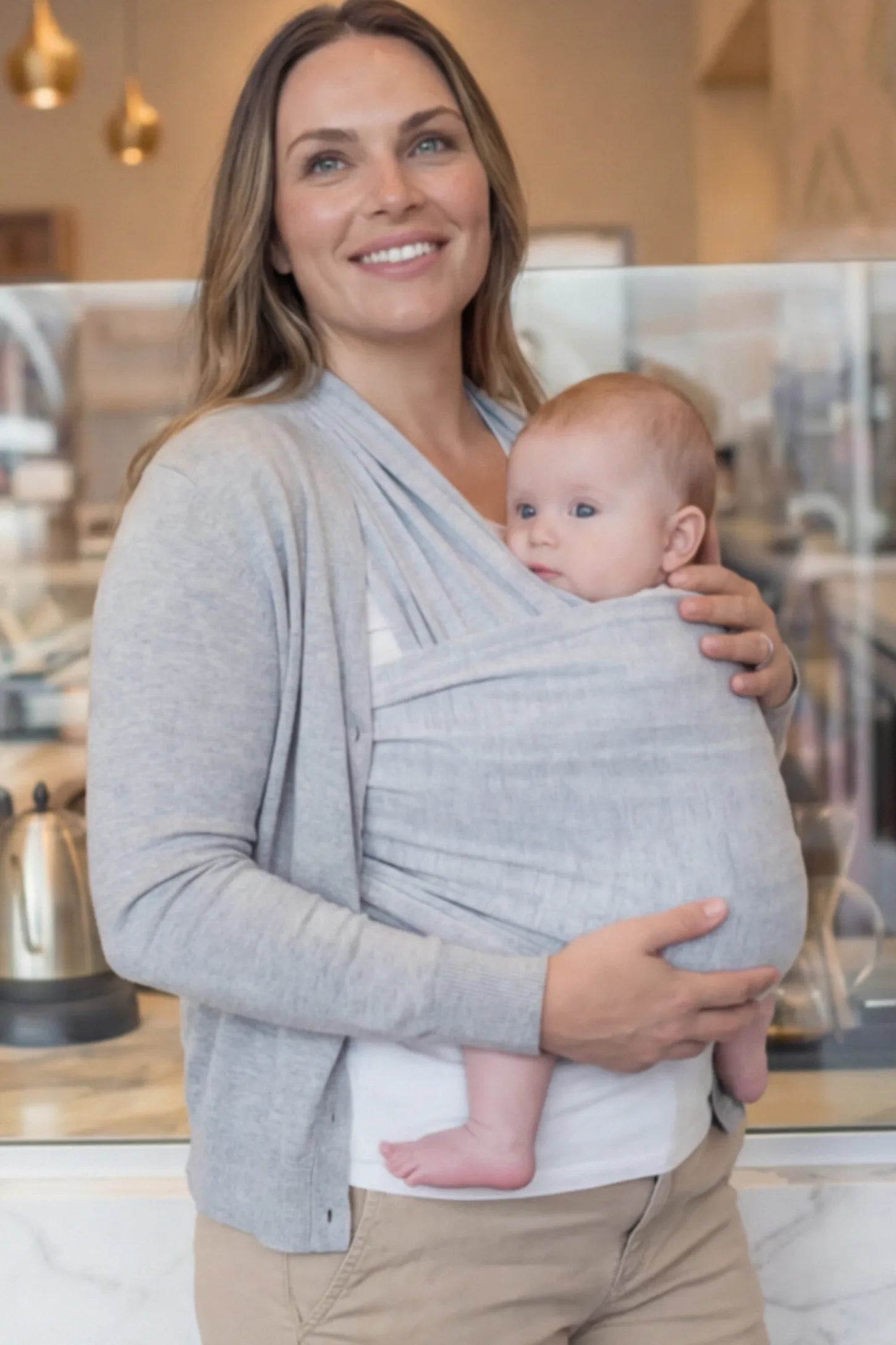 Soft Stretch Adjustable Baby Wrap Carrier Soft Stretch Adjustable Baby Wrap Carrier in Gray featuring a polyester blend holding a baby.