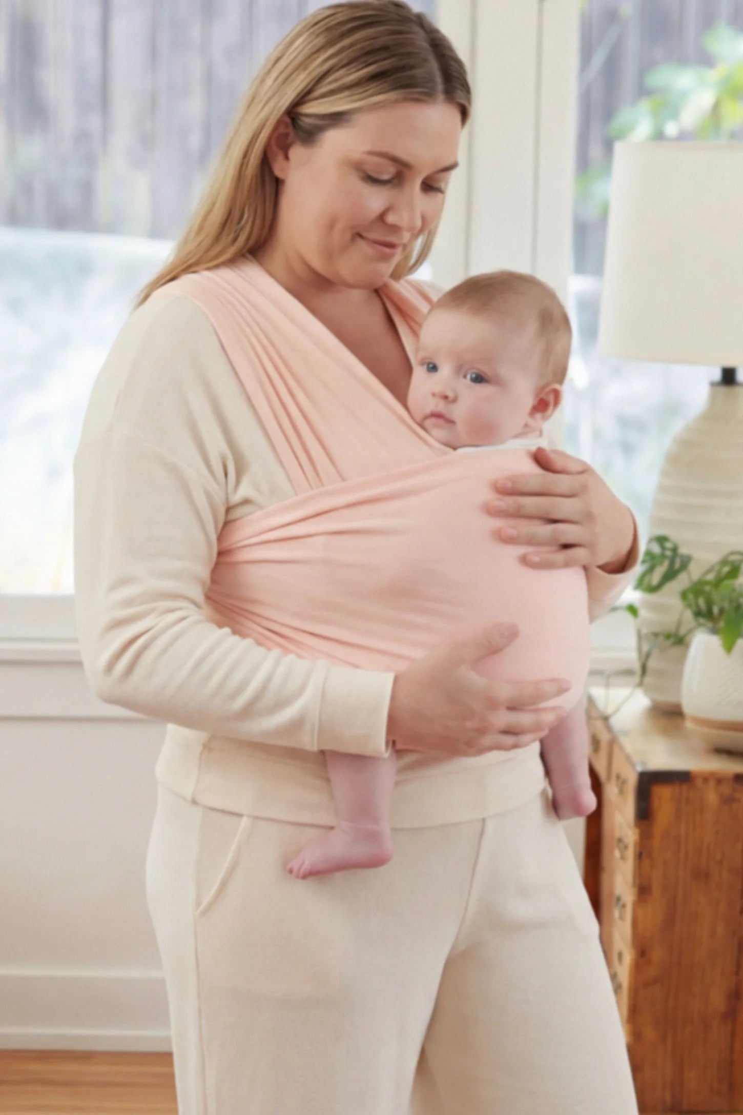 Soft Stretch Adjustable Baby Wrap Carrier Soft Stretch Adjustable Baby Wrap Carrier in Lotus Root Pink featuring a polyester blend holding a baby.