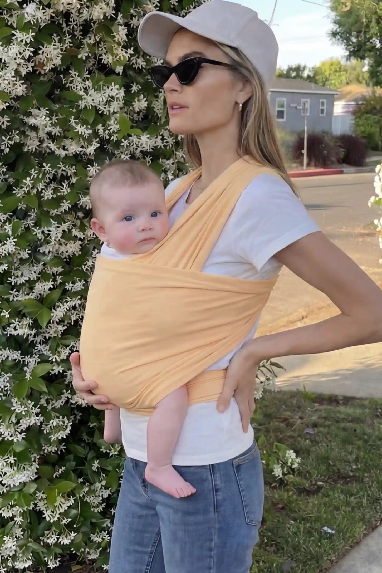 Soft Stretch Adjustable Baby Wrap Carrier Soft Stretch Adjustable Baby Wrap Carrier in pale Yellow featuring a polyester blend holding a baby.