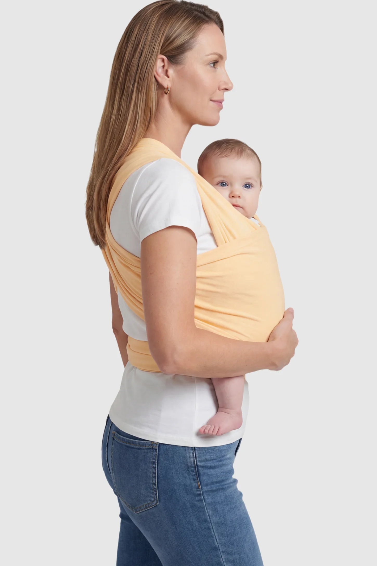 Soft Stretch Adjustable Baby Wrap Carrier Soft Stretch Adjustable Baby Wrap Carrier in pale Yellow featuring a polyester blend holding a baby.