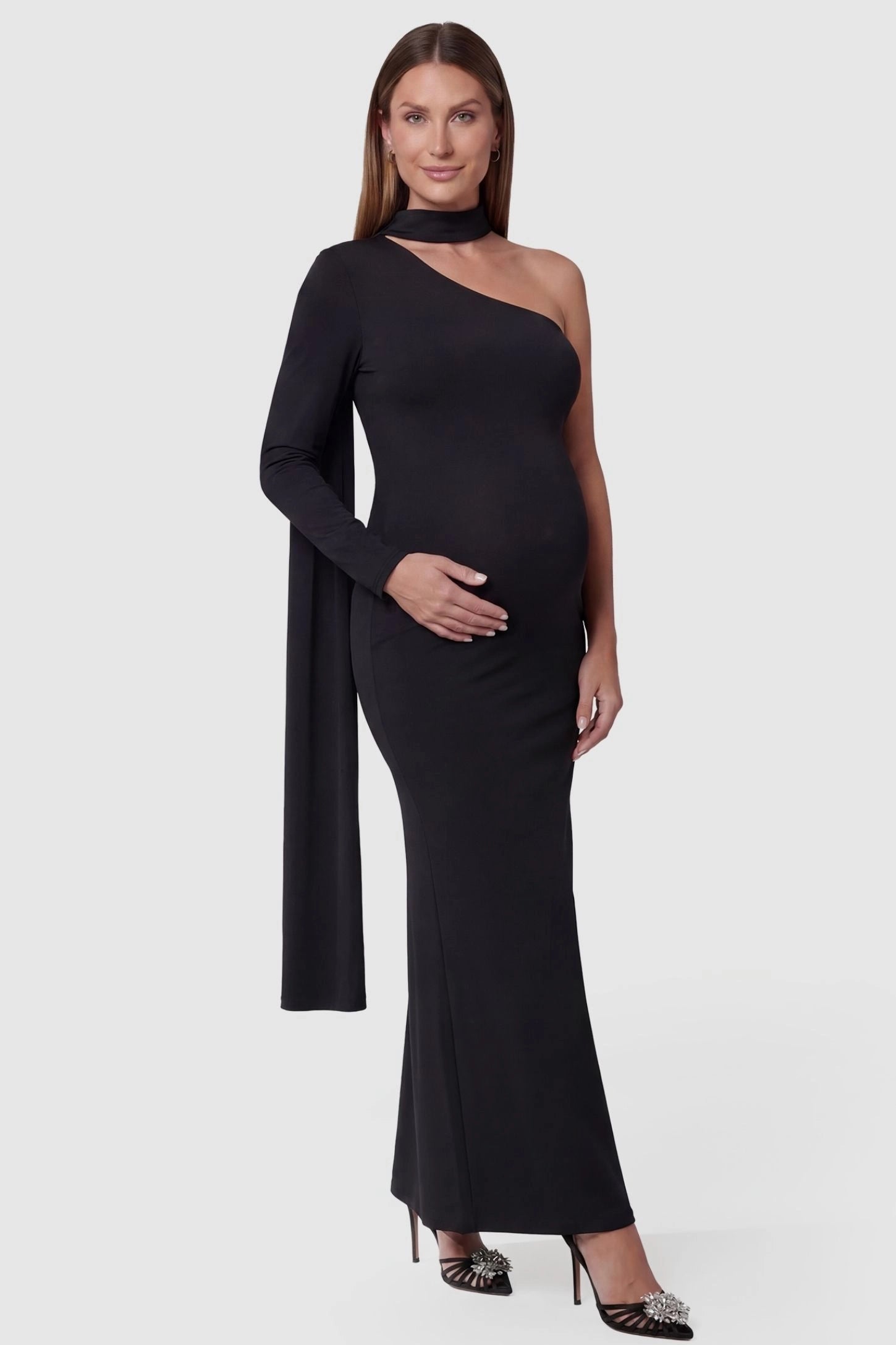 Soft Stretch One-Sleeve Halter Maternity Dress in Black featuring a timeless sculpted fit on a pregnant model front view.