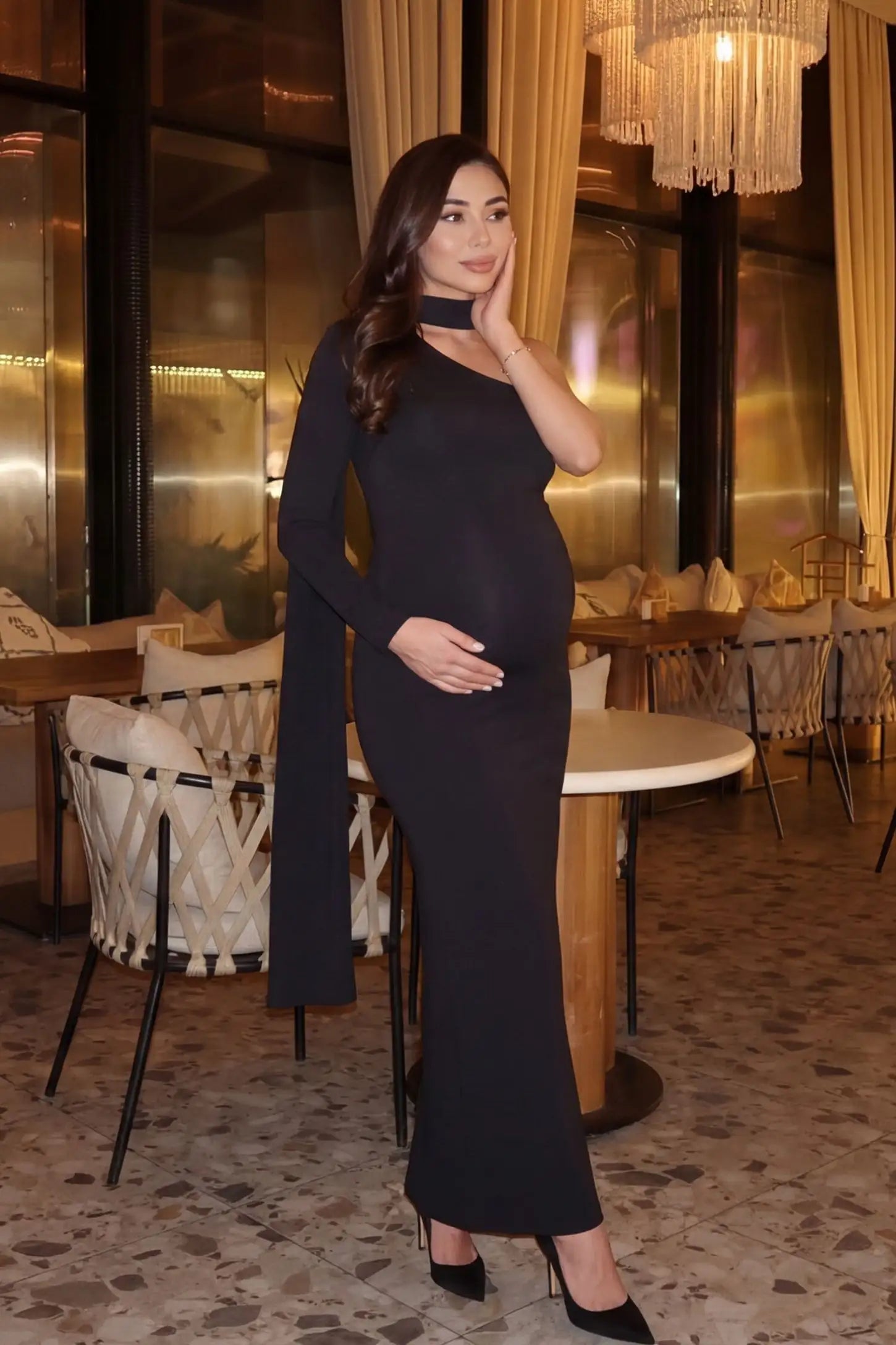 Soft Stretch One-Sleeve Halter Maternity Dress Black Soft Stretch One-Sleeve Halter Maternity Dress featuring a versatile evening look on a pregnant model.