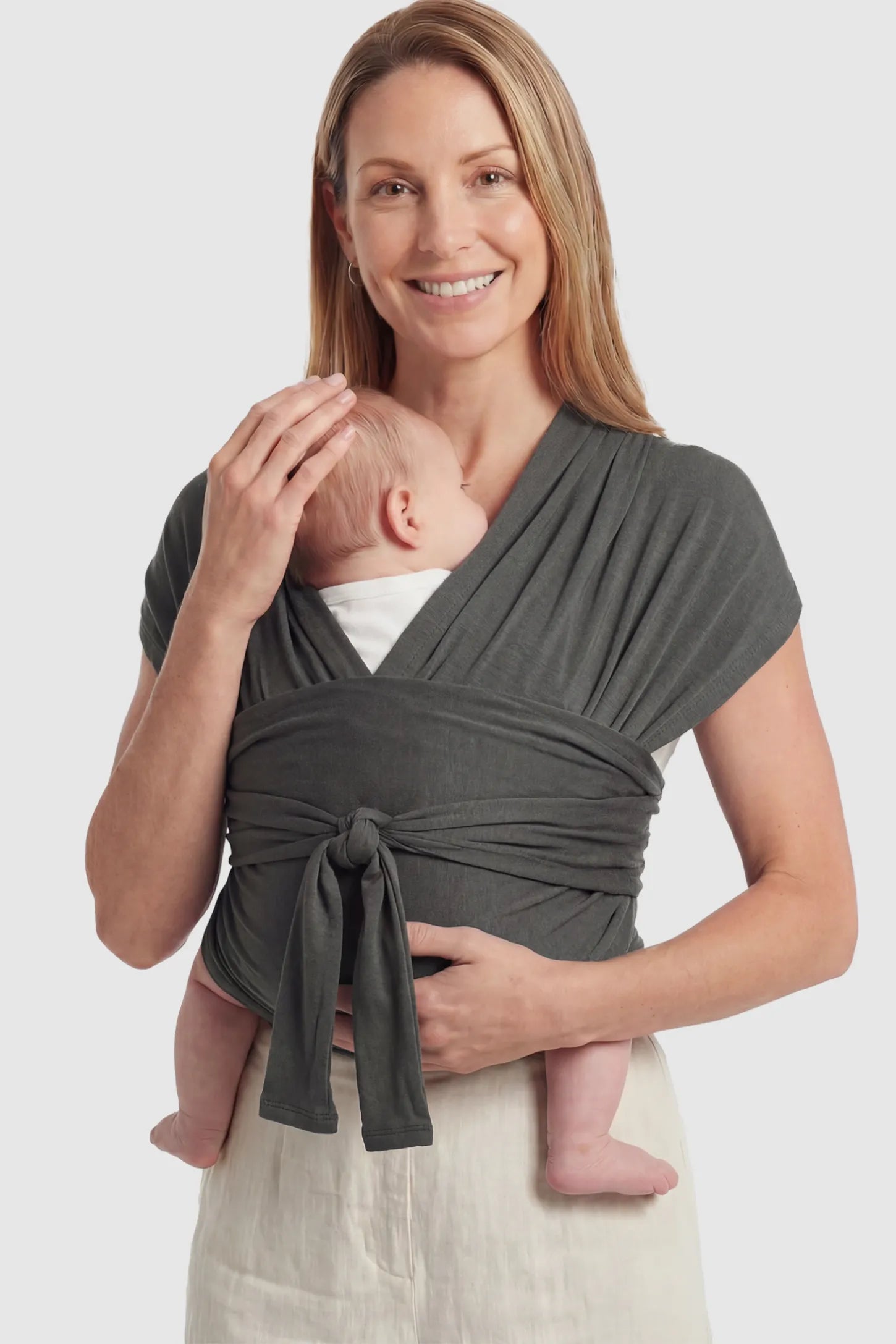 Soft Stretch Skin Friendly Baby Wrap Carrier Soft Stretch Skin Friendly Baby Wrap Carrier in Dark Gray featuring a secure front-tie knot on a mother holding her newborn showing front.