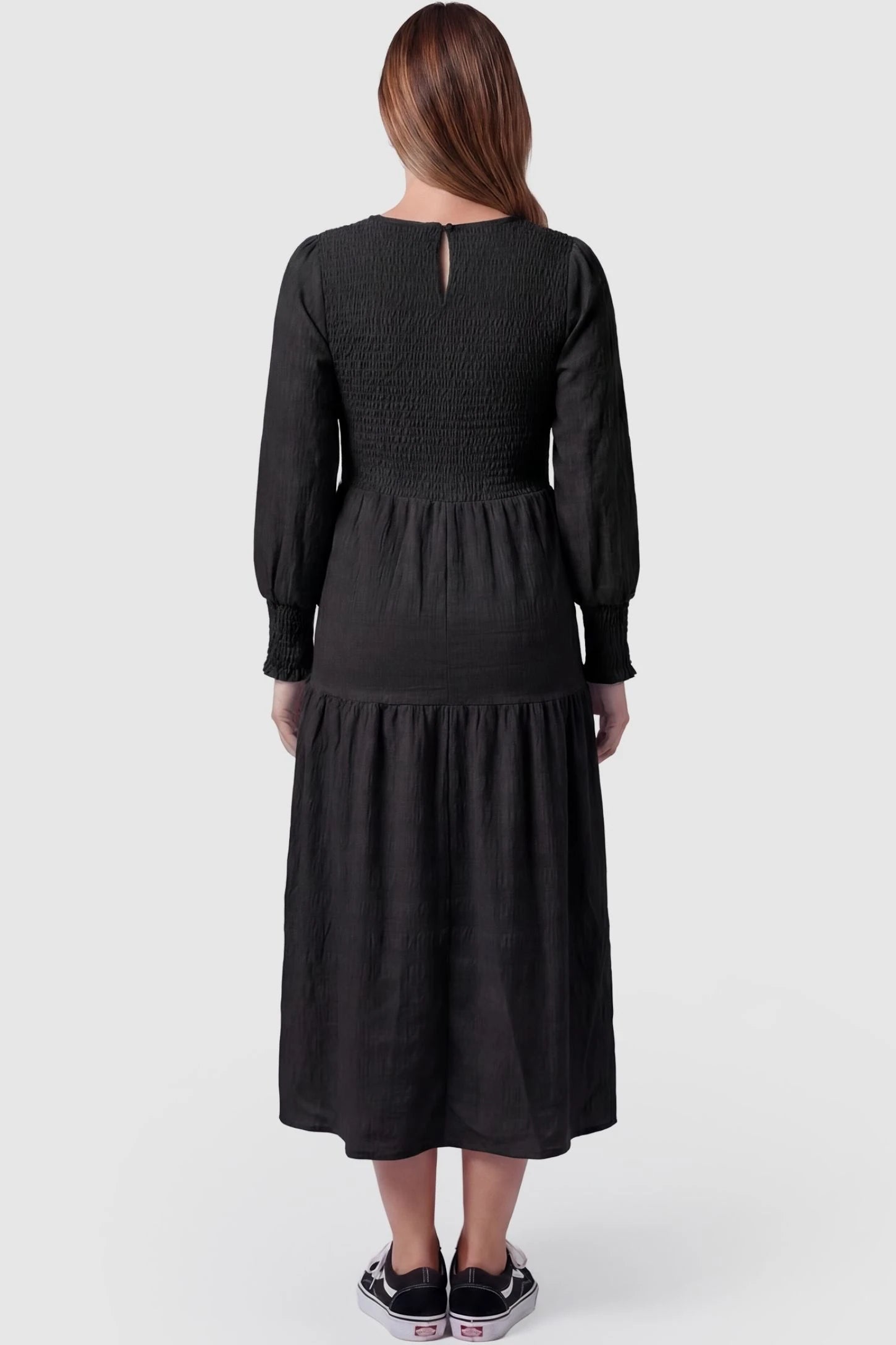 Solid Color Tiered Style Midi Maternity Dress Solid Color Tiered Style Midi Maternity Dress in black featuring a smocked bodice on a pregnant model, back view.