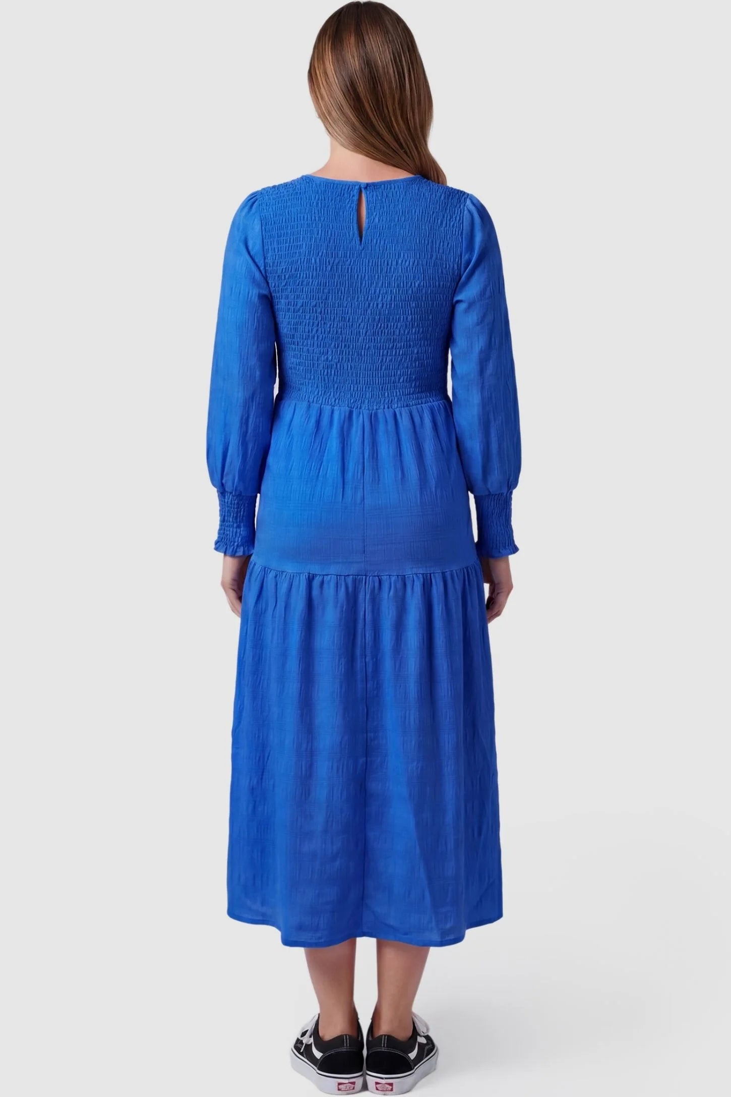Solid Color Tiered Style Midi Maternity Dress Solid Color Tiered Style Midi Maternity Dress in blue featuring a smocked bodice on a pregnant model, back view.