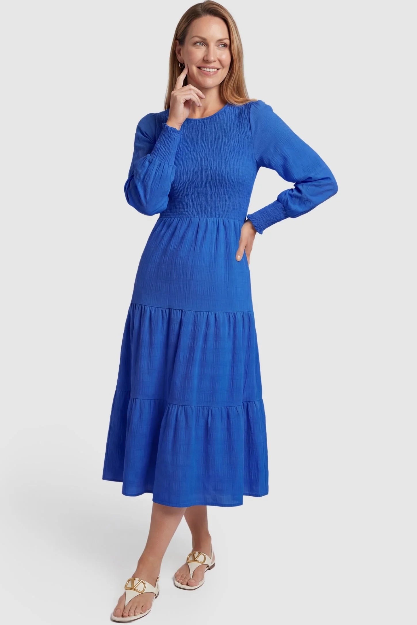 Solid Color Tiered Style Midi Maternity Dress Solid Color Tiered Style Midi Maternity Dress in blue featuring a smocked bodice on a non-pregnant model, postpartum view.