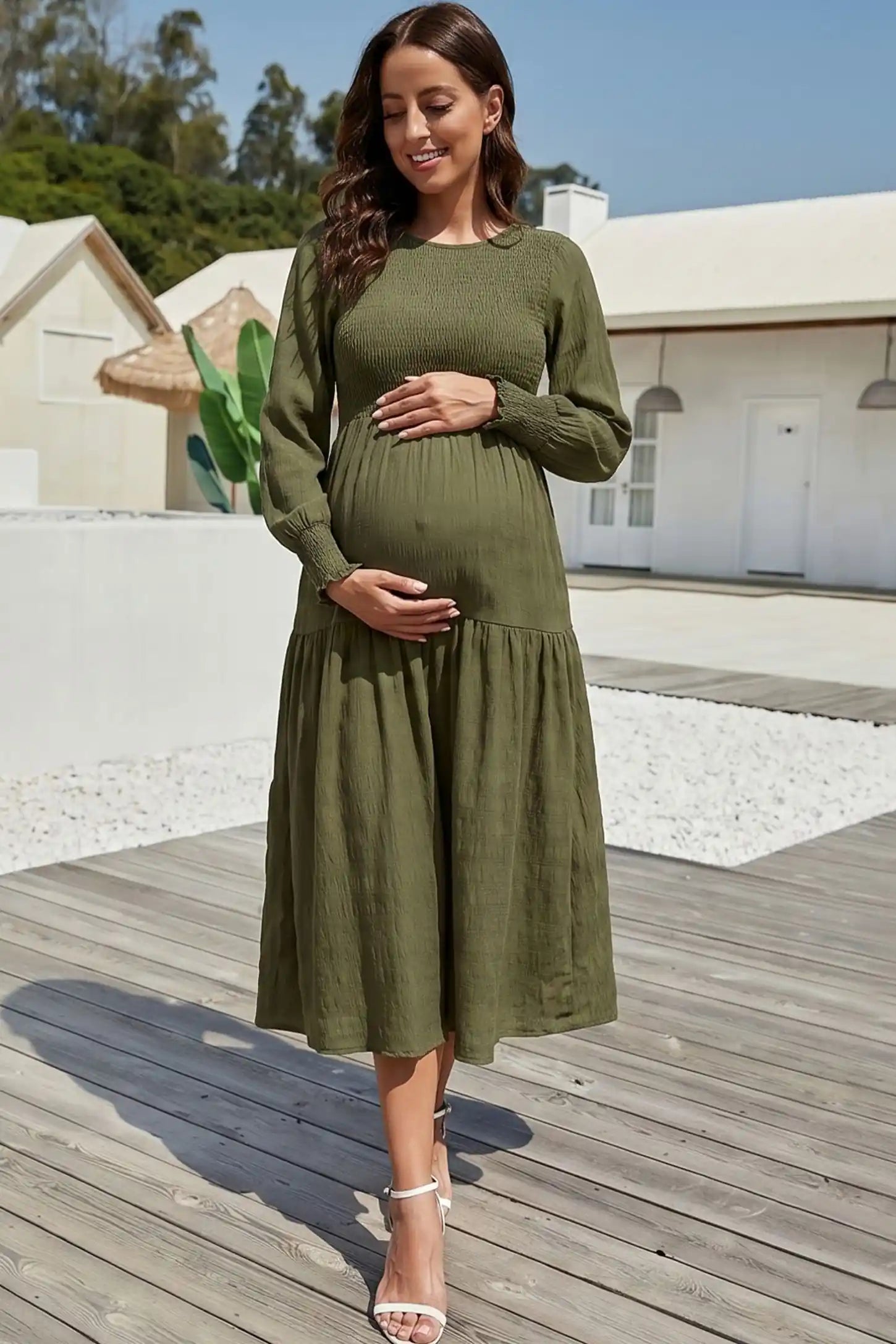 Solid Color Tiered Style Midi Maternity Dress Solid Color Tiered Style Midi Maternity Dress in green featuring a smocked bodice on a pregnant model, editorial lifestyle view.
