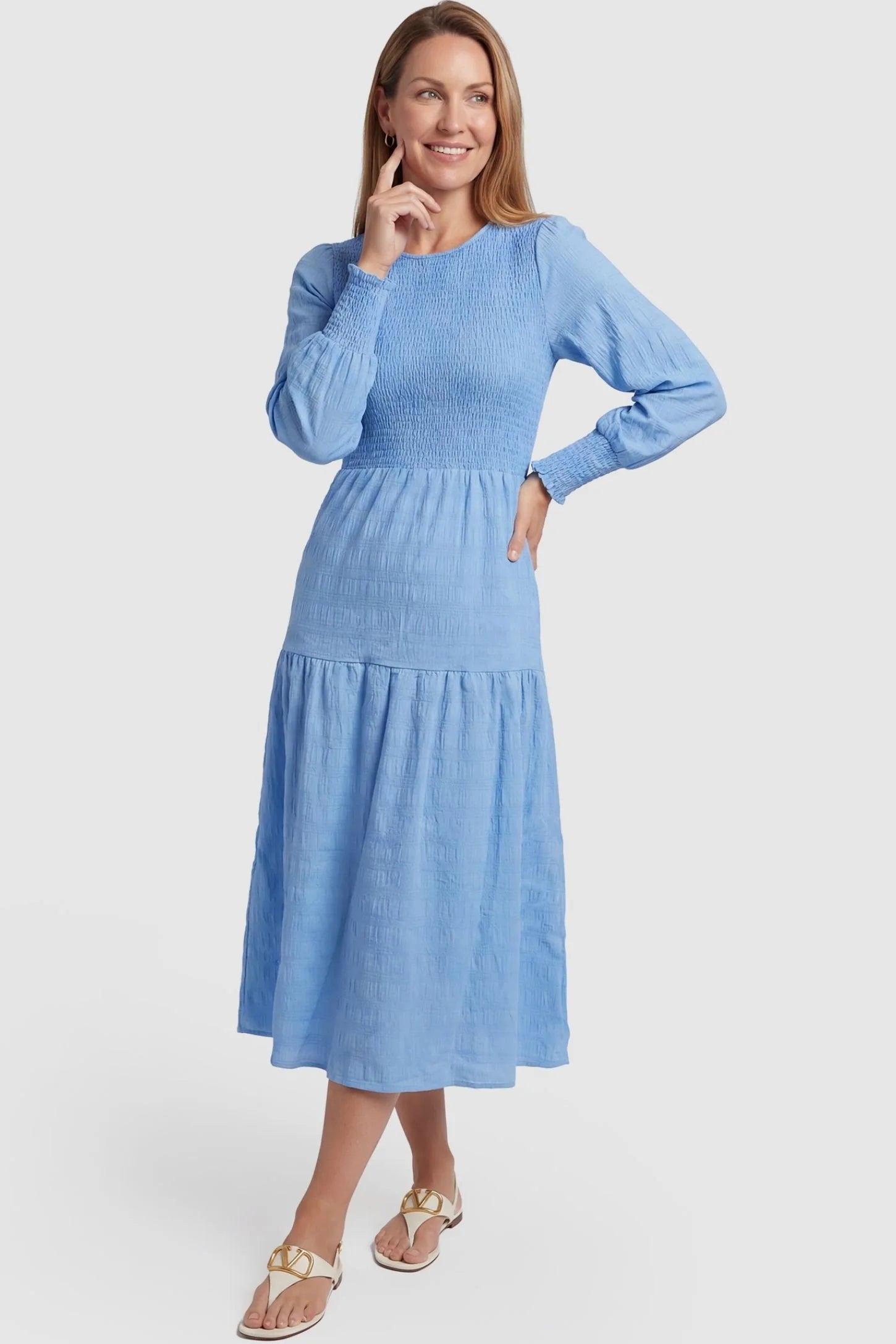 Solid Color Tiered Style Midi Maternity Dress Solid Color Tiered Style Midi Maternity Dress in light blue featuring a smocked bodice on a non-pregnant model, postpartum view.