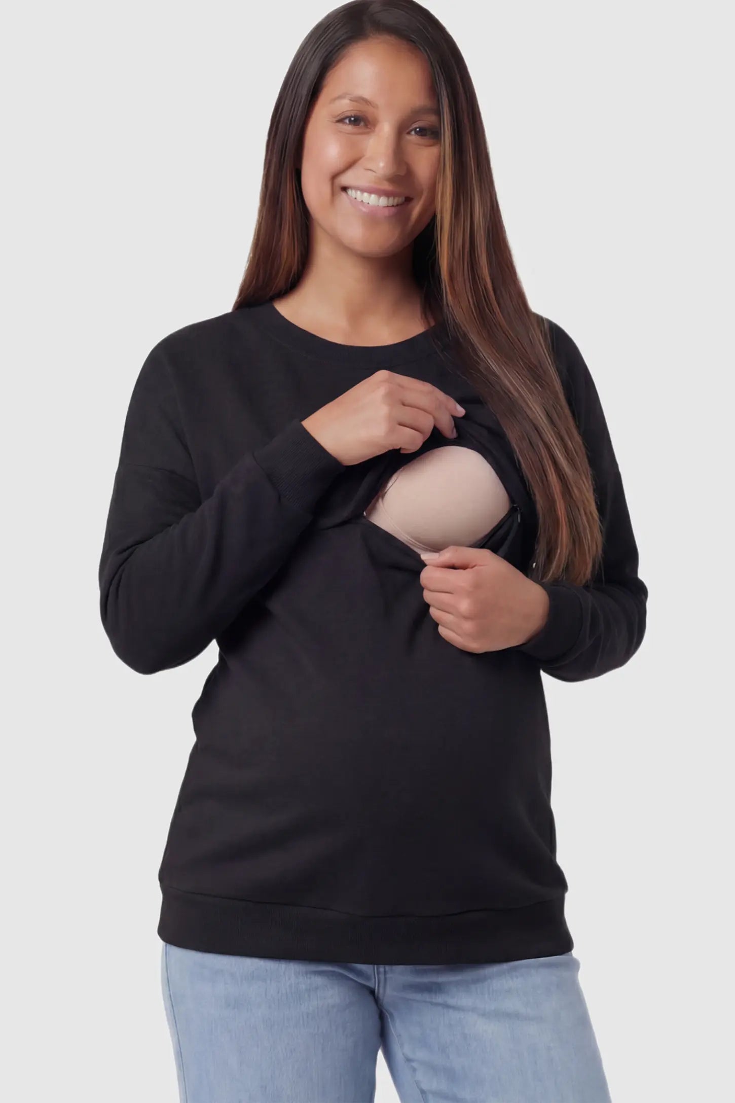 Solid Long Sleeve Maternity & Nursing Sweatshirt Solid Long Sleeve Maternity & Nursing Sweatshirt in Black featuring a hidden zip raised seam on a pregnant model showing nursing access.