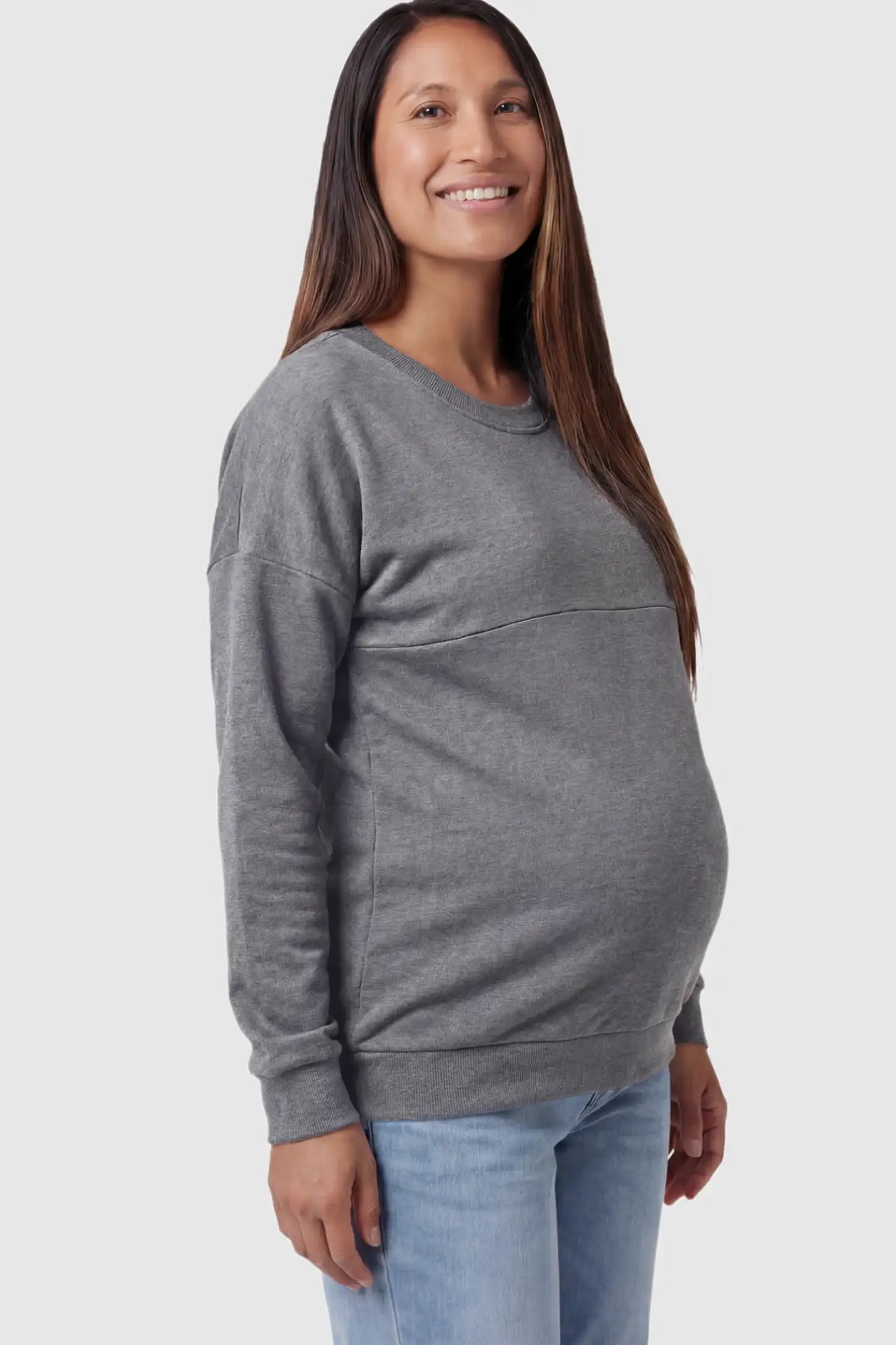 Solid Long Sleeve Maternity & Nursing Sweatshirt Solid Long Sleeve Maternity & Nursing Sweatshirt in Dark Gray featuring a hidden zip raised seam on a pregnant model showing side.