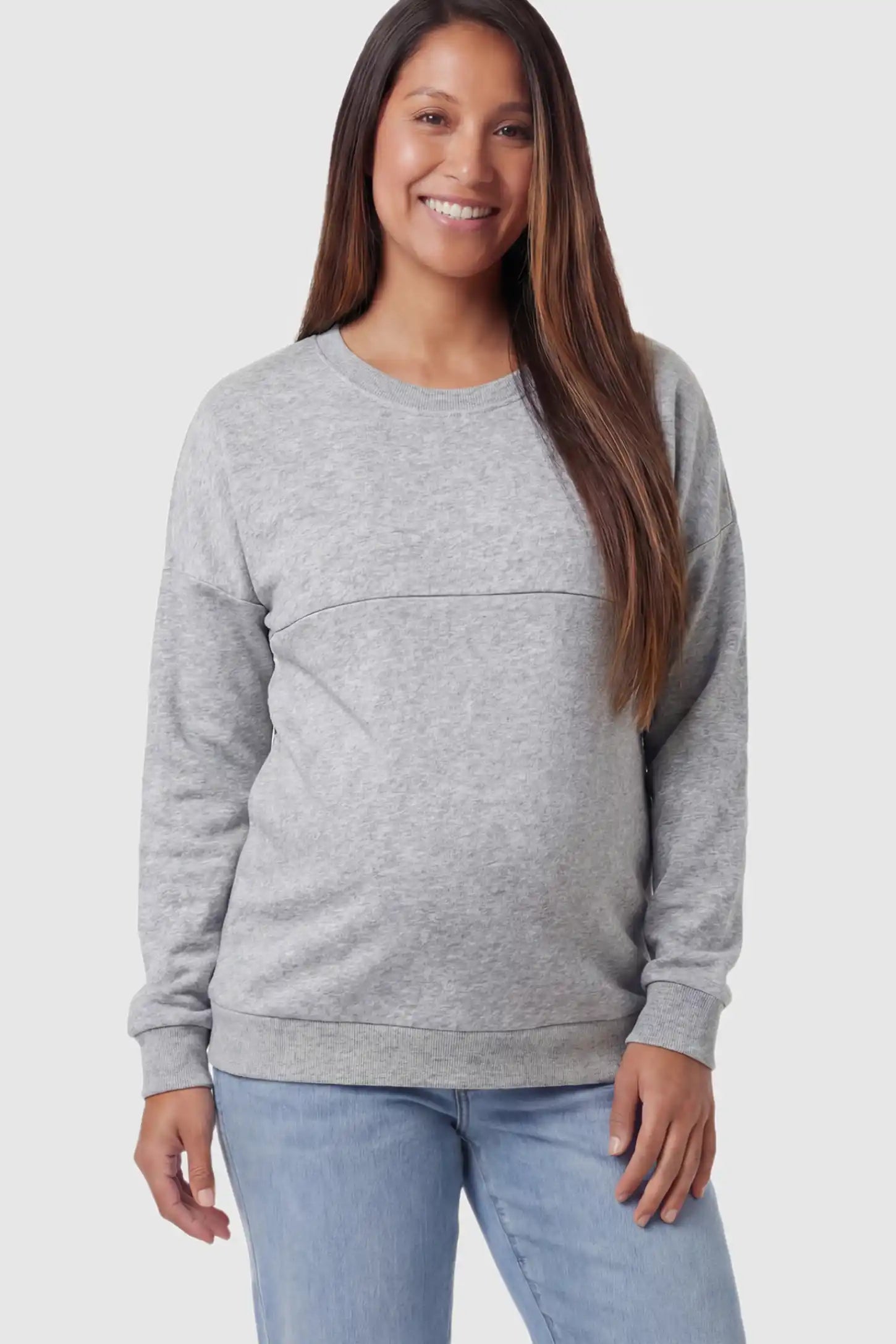 Solid Long Sleeve Maternity & Nursing Sweatshirt Solid Long Sleeve Maternity & Nursing Sweatshirt in Light Gray featuring a hidden zip raised seam on a pregnant model posing front.