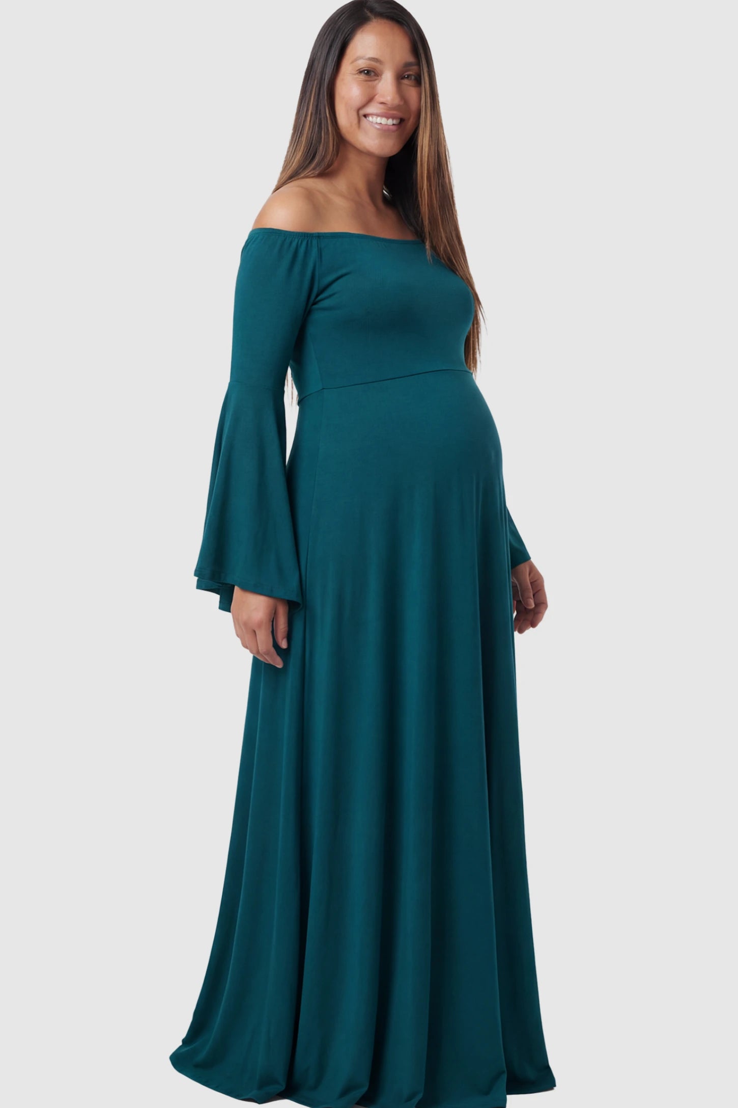 Solid Off Shoulder Bell Sleeve Maternity Maxi Dress Solid Off Shoulder Bell Sleeve Maternity Maxi Dress in Navy Blue featuring Bell sleeves on a pregnant model showing side.