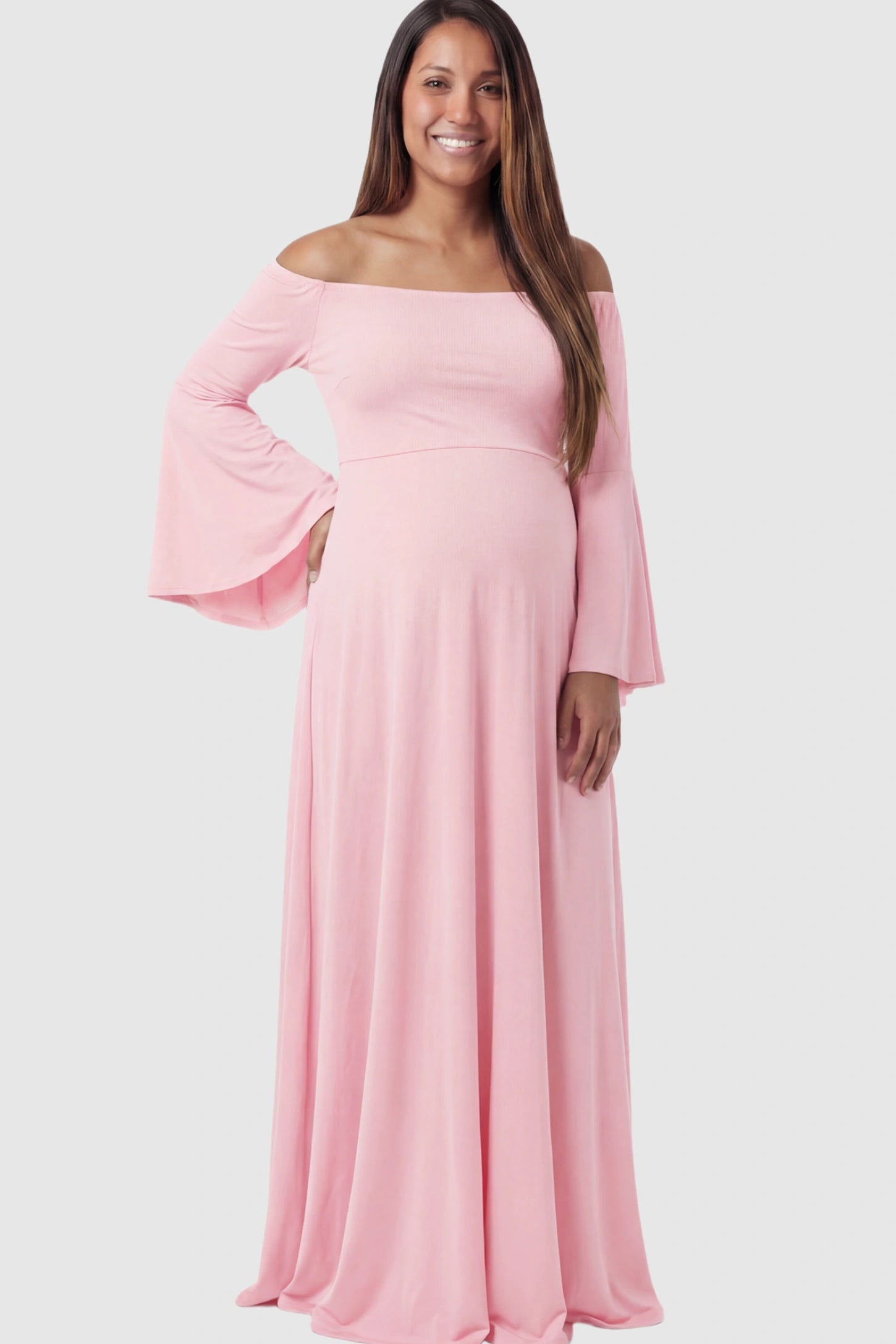 Solid Off Shoulder Bell Sleeve Maternity Maxi Dress Solid Off Shoulder Bell Sleeve Maternity Maxi Dress in Pink featuring Bell sleeves on a pregnant model showing front.