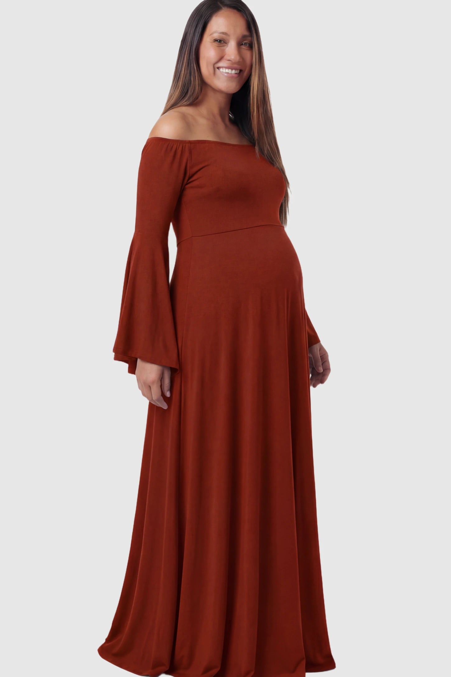 Solid Off Shoulder Bell Sleeve Maternity Maxi Dress Solid Off Shoulder Bell Sleeve Maternity Maxi Dress in Red featuring Bell sleeves on a pregnant model showing side.
