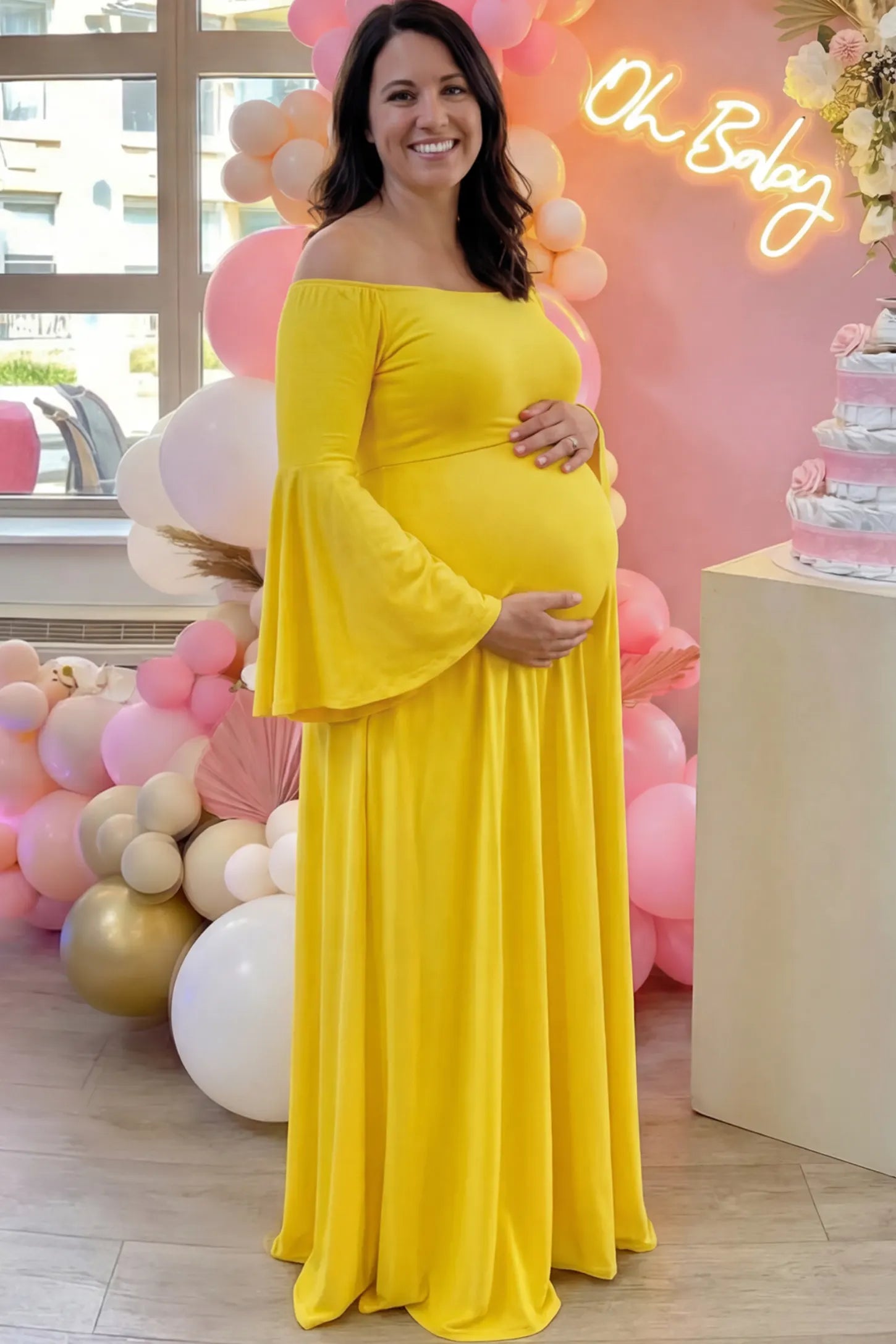 Solid Off Shoulder Bell Sleeve Maternity Maxi Dress Solid Off Shoulder Bell Sleeve Maternity Maxi Dress in Yellow featuring Bell sleeves on a pregnant model showing side.
