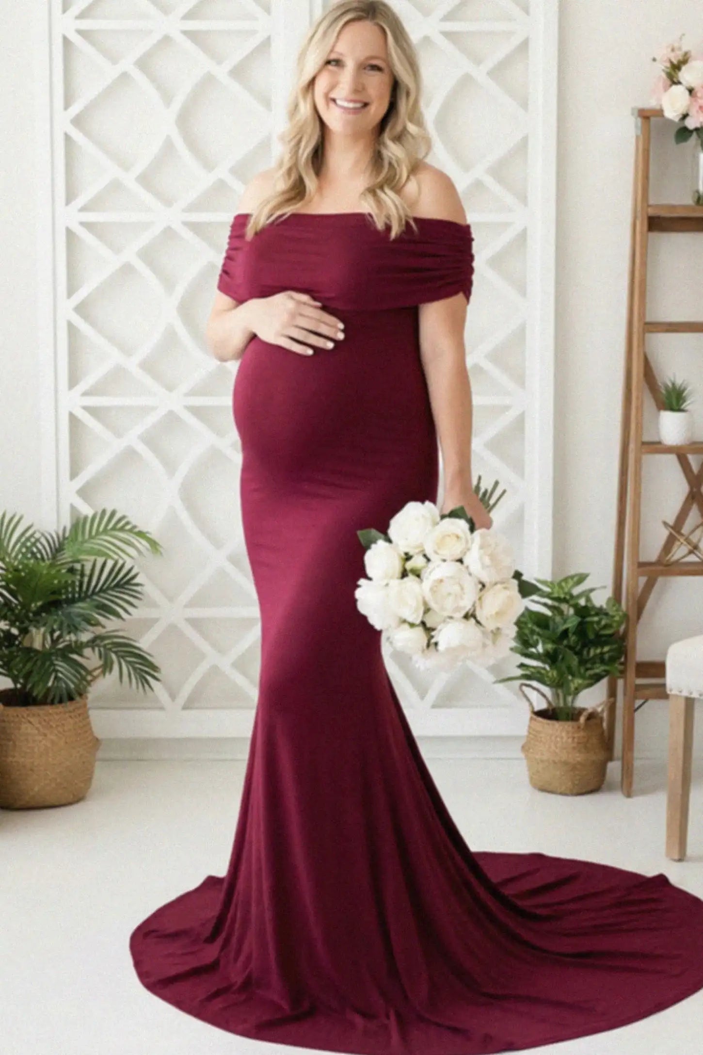 Solid Off Shoulder Maternity Photoshoot Gown Solid Off-Shoulder Maternity Photoshoot Gown in red featuring subtle train on a pregnant woman showing front.