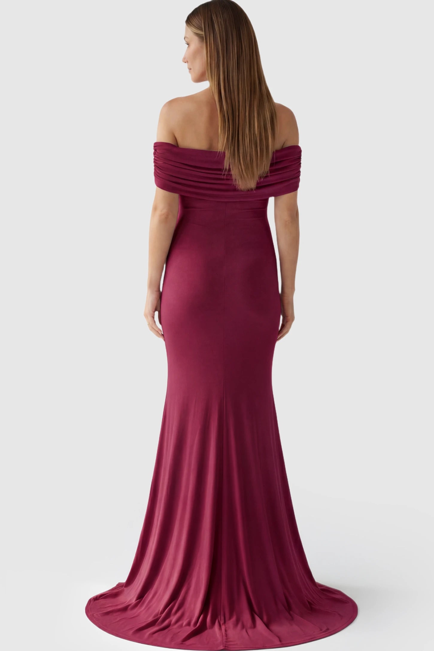 Solid Off Shoulder Maternity Photoshoot Gown Solid Off-Shoulder Maternity Photoshoot Gown in red featuring subtle train on a pregnant model showing back.