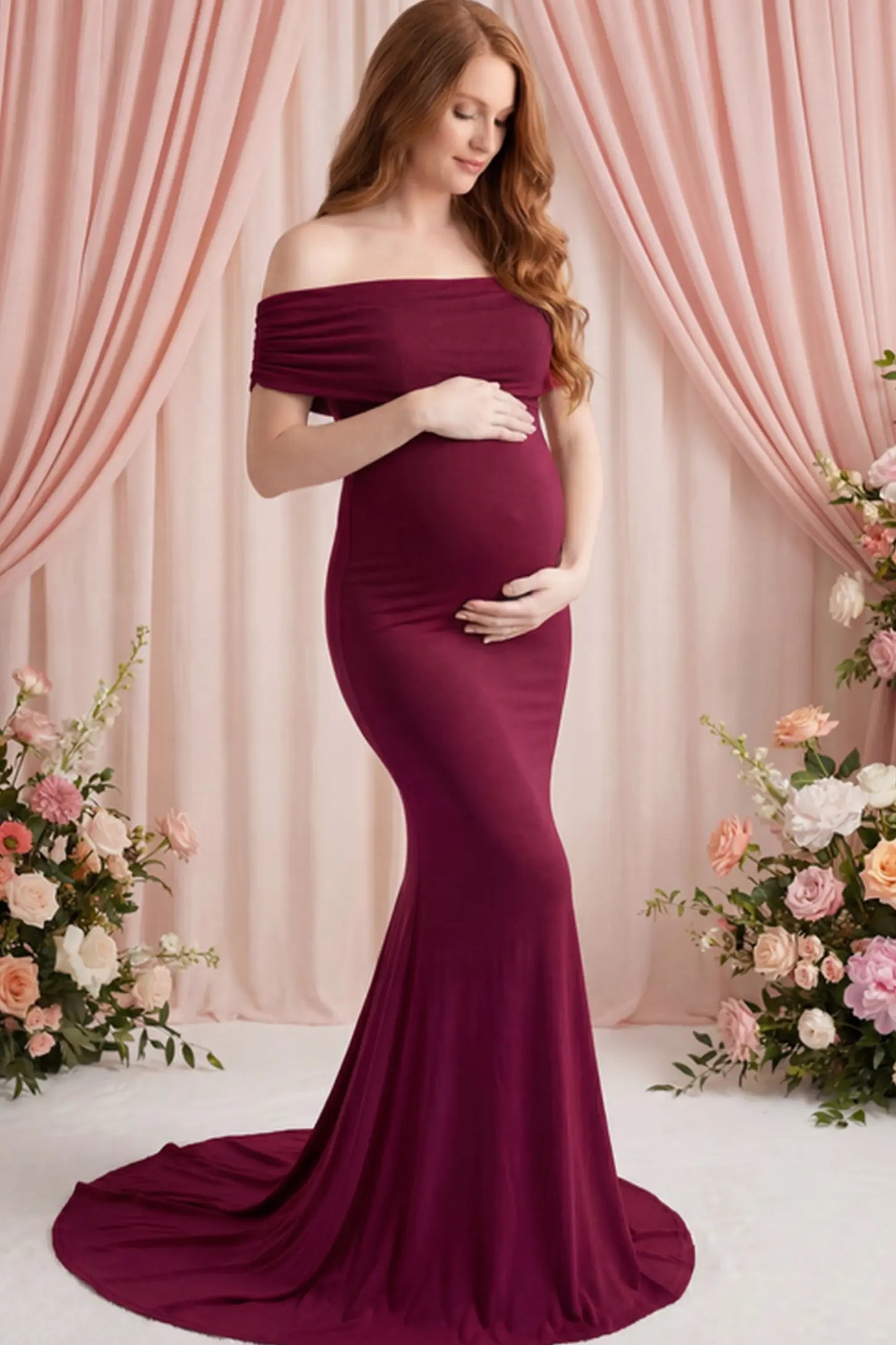 Solid Off Shoulder Maternity Photoshoot Gown Solid Off-Shoulder Maternity Photoshoot Gown in red featuring subtle train on a pregnant woman posing front.