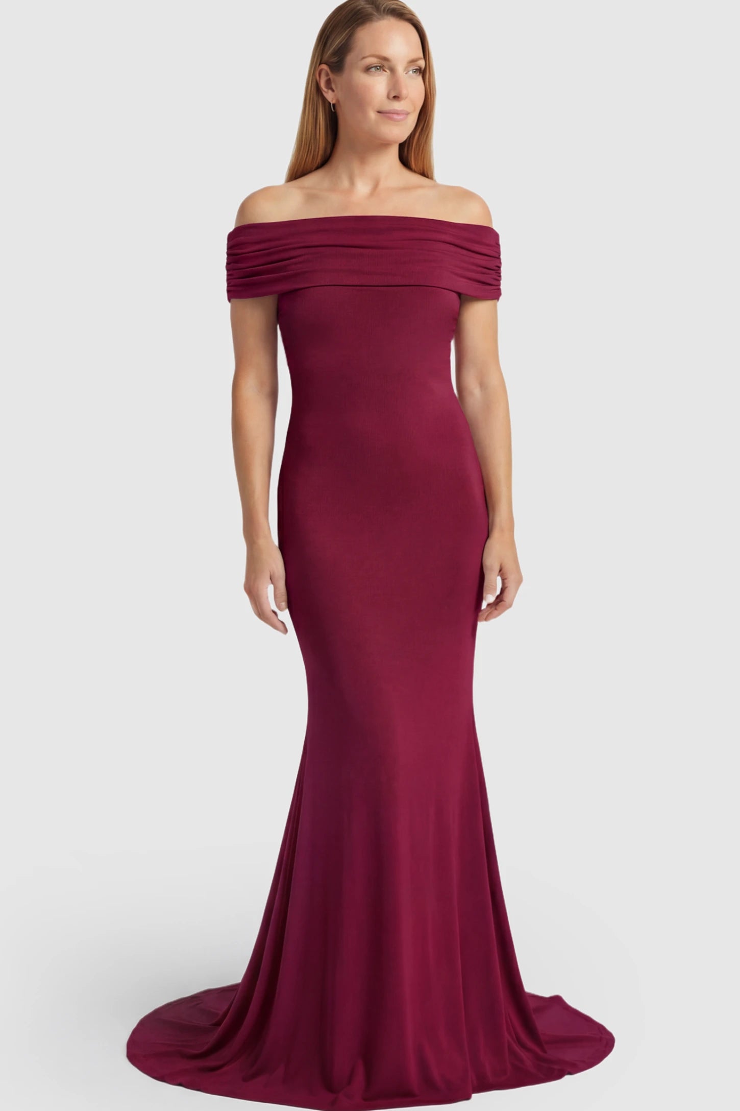 Solid Off Shoulder Maternity Photoshoot Gown Solid Off-Shoulder Maternity Photoshoot Gown in red featuring subtle train on a postpartum model showing front.