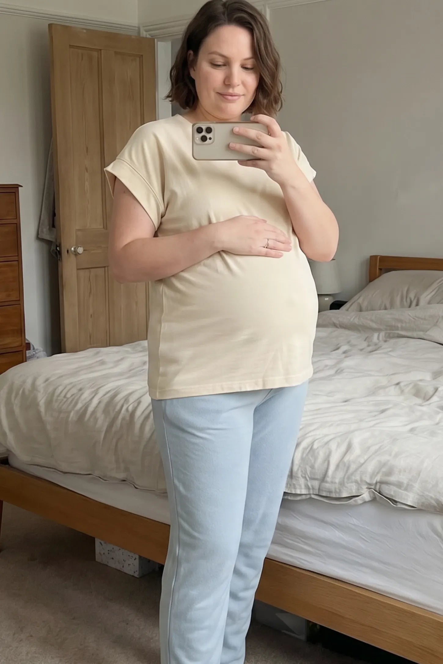 Solid Round Neck Cap Sleeve Maternity Top Solid Round Neck Cap Sleeve Maternity Top in Beige featuring breathable fabric on a pregnant model in indoor setting, front view.