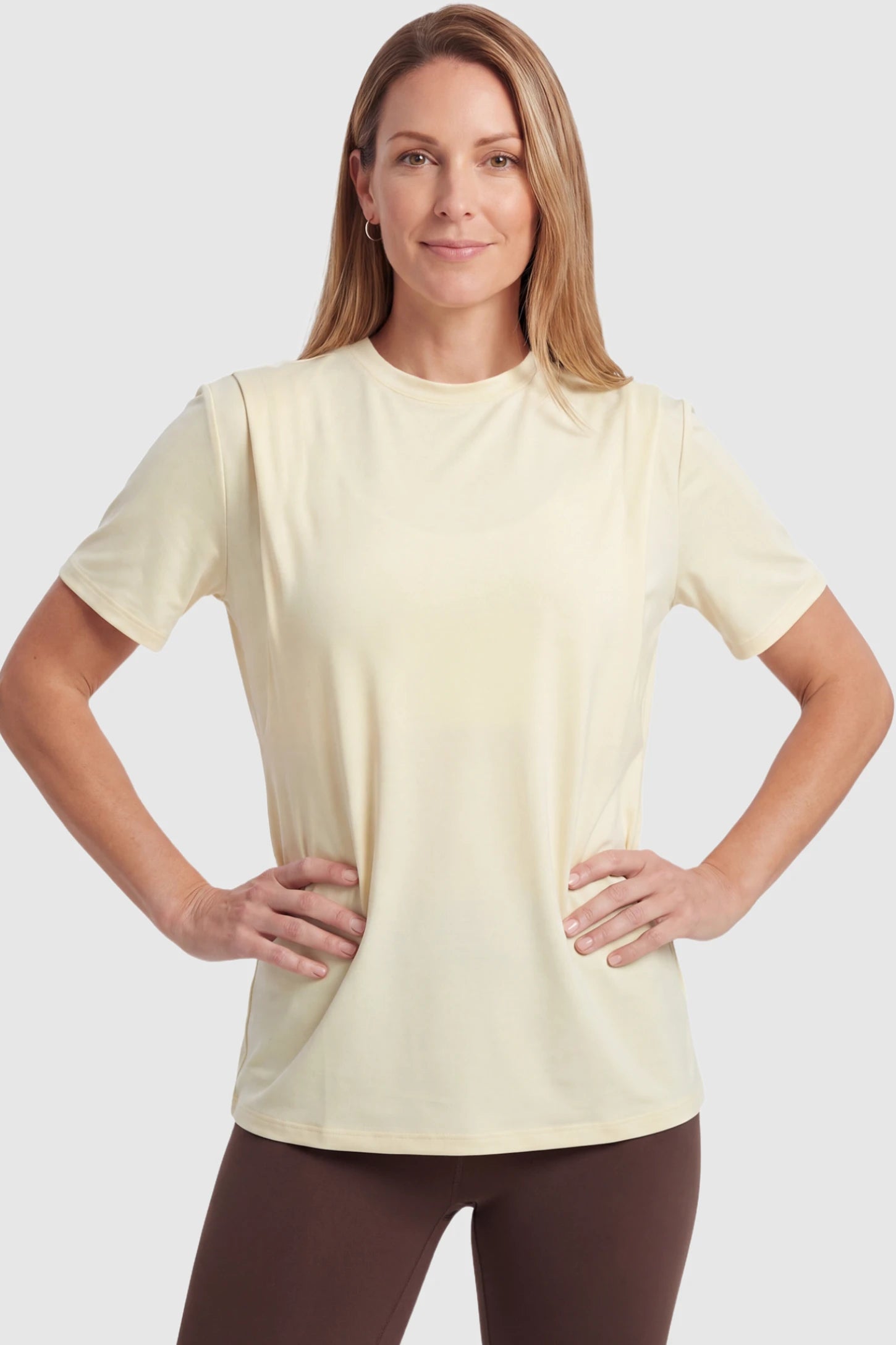 Solid Round Neck Short Sleeve Maternity Top Solid Round Neck Short Sleeve Maternity Top in Beige featuring a soft-touch finish and relaxed fit on a postpartum model, front view.
