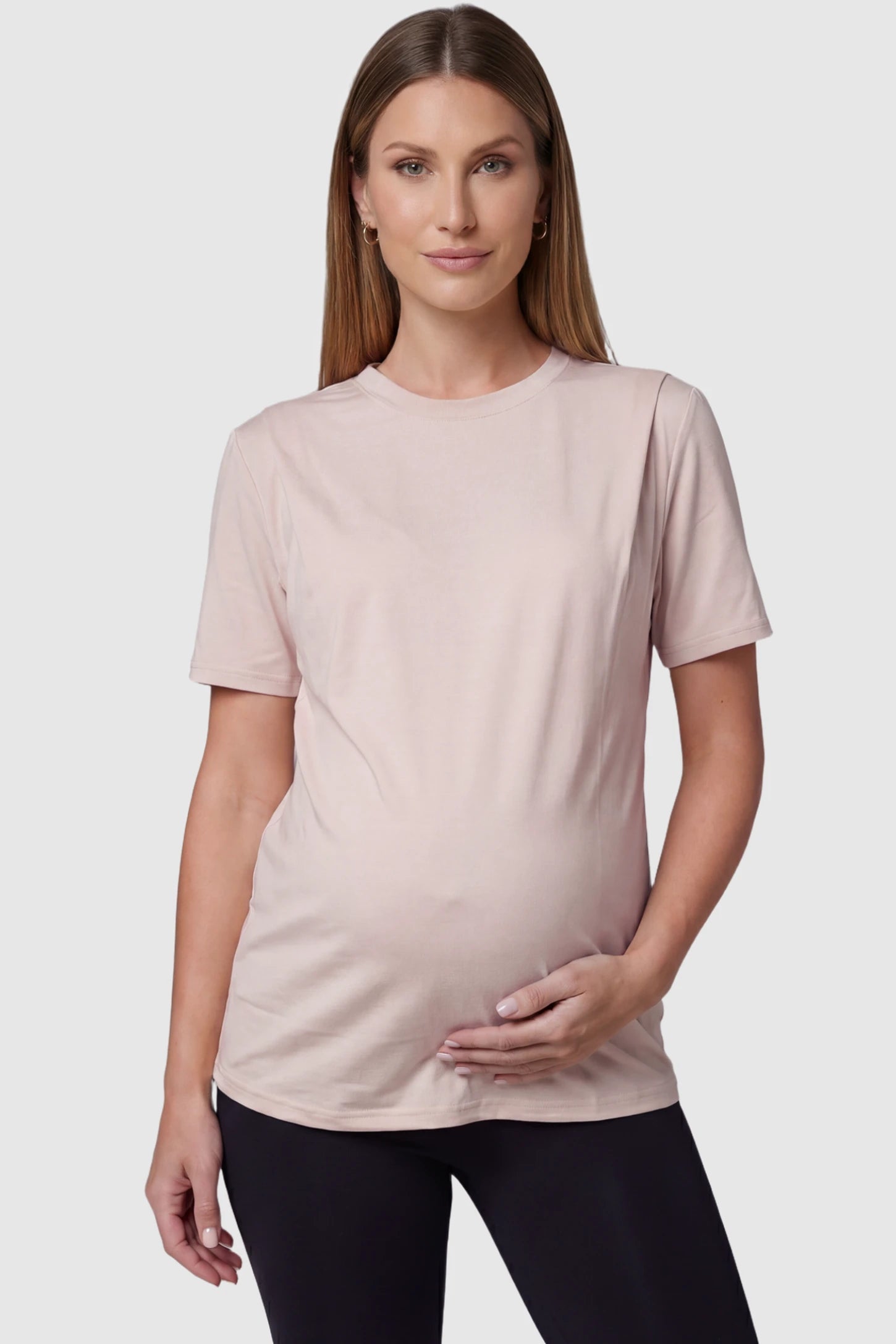 Solid Round Neck Short Sleeve Maternity Top Solid Round Neck Short Sleeve Maternity Top in Brown featuring a soft-touch finish and relaxed fit on a pregnant model, front view.